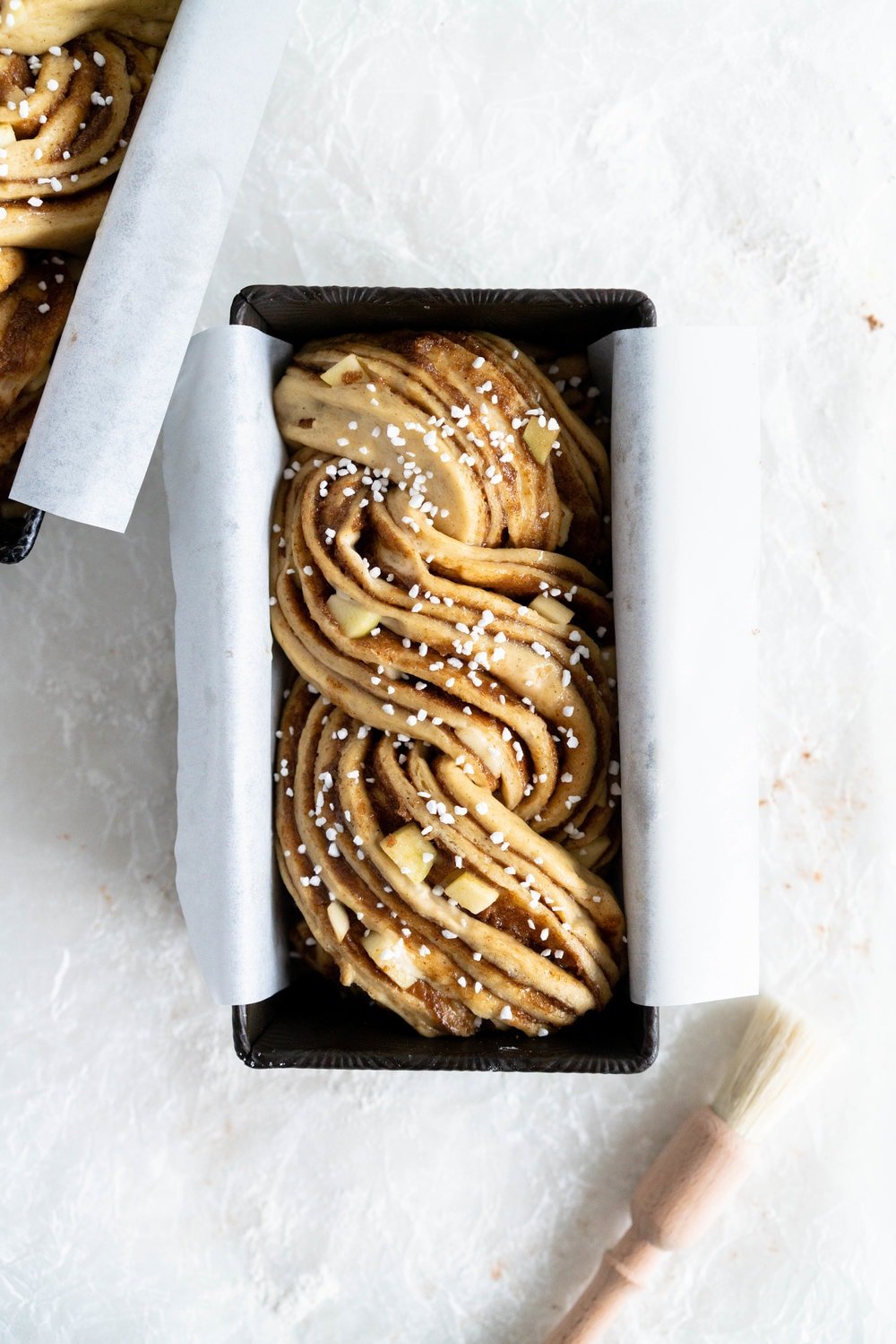 Apple and Cardamom brioche babka - lightly spiced babka dough is filled with a spiced brown sugar mixture and fresh apple, then rolled into a tight babka swirl. Inspired by the swedish cinnamon roll, this is a perfect fall baking project. #babka #cardamom #brioche