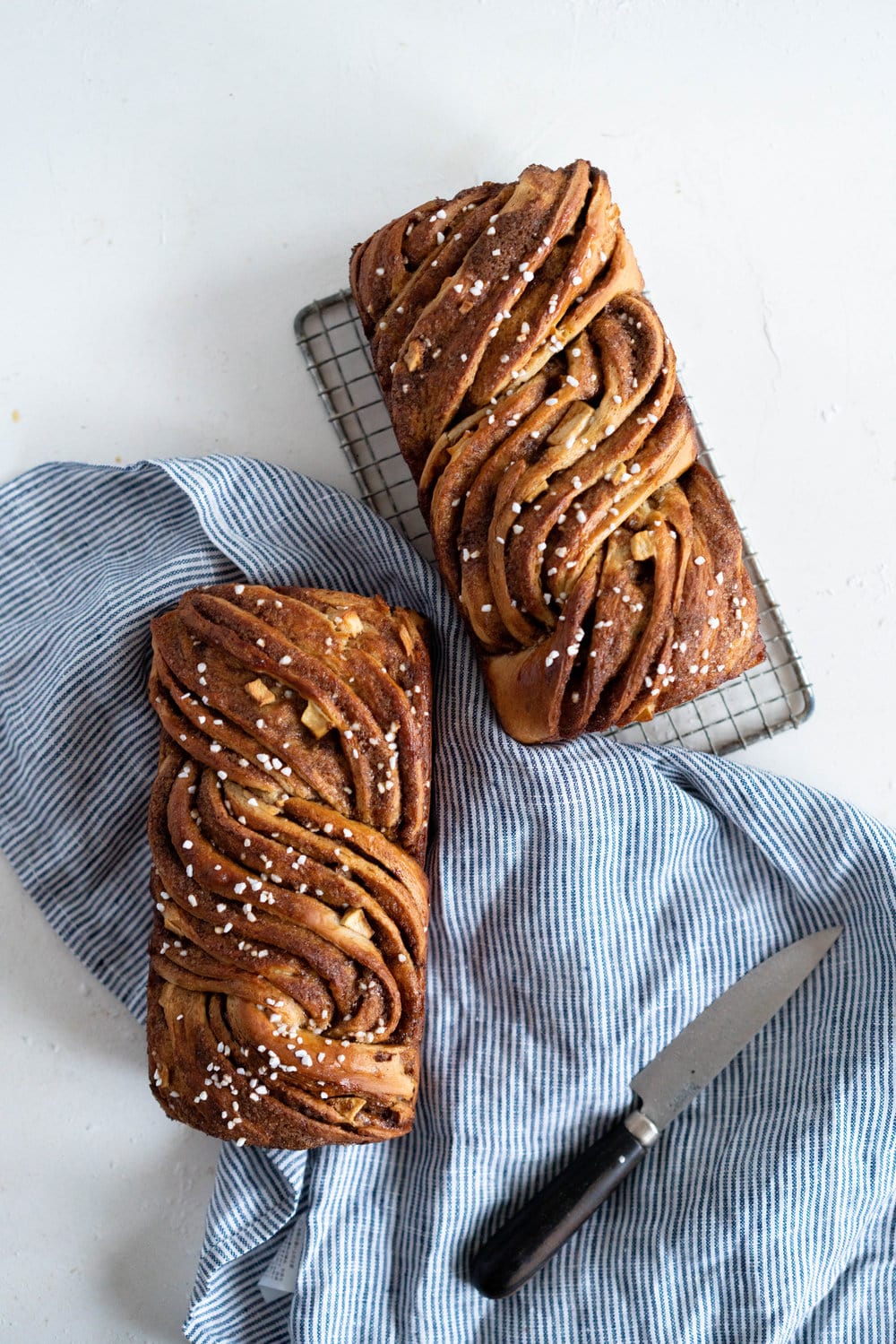 Apple and Cardamom brioche babka - lightly spiced babka dough is filled with a spiced brown sugar mixture and fresh apple, then rolled into a tight babka swirl. Inspired by the swedish cinnamon roll, this is a perfect fall baking project. #babka #cardamom #brioche
