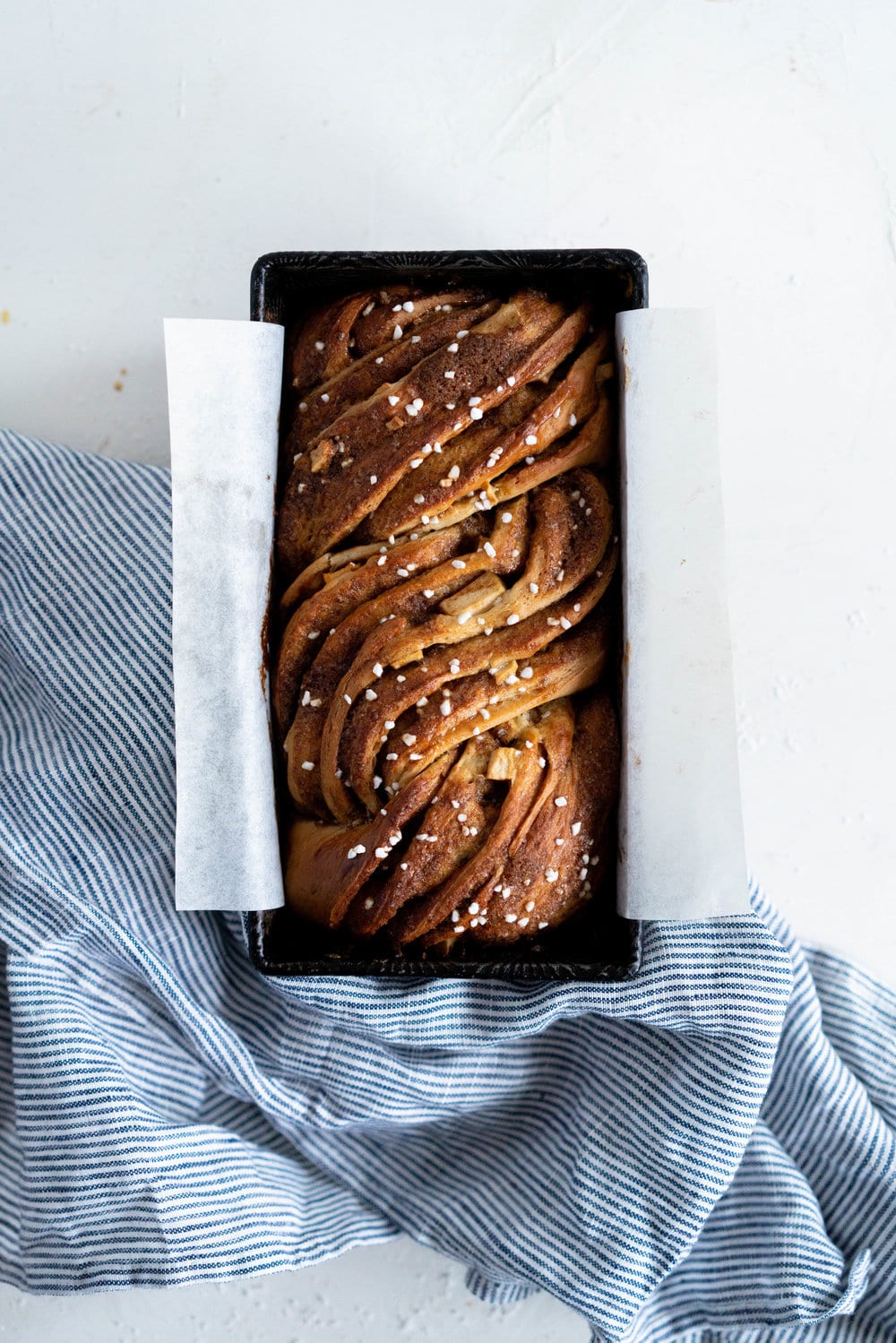 Apple and Cardamom brioche babka - lightly spiced babka dough is filled with a spiced brown sugar mixture and fresh apple, then rolled into a tight babka swirl. Inspired by the swedish cinnamon roll, this is a perfect fall baking project. #babka #cardamom #brioche