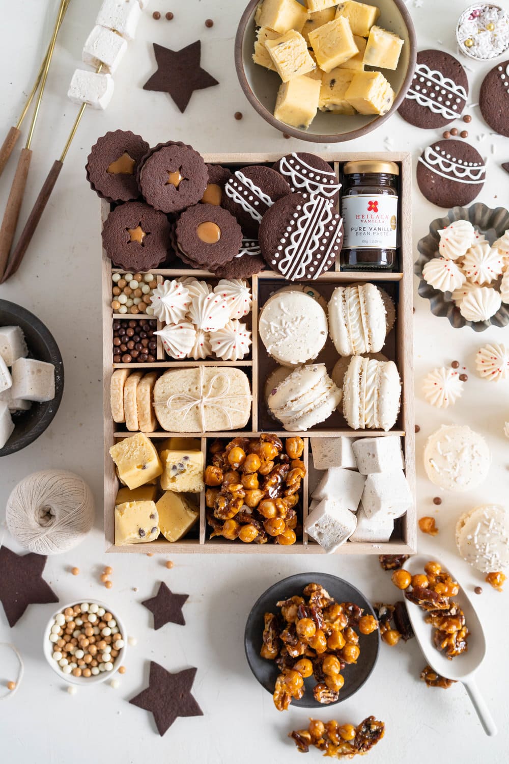 The Ultimate Vanilla Bean Christmas Box. All of the christmas treats for your recipe planning for this upcoming holiday season! Chocolate Shortbread cookies with Vanilla bean Dulce de Leche filling, vanilla bean meringues, vanilla bean macarons, Vanilla bean shortbread, vanilla bean passionfruit fudge, vanilla bean salted caramel nut mix, and vanilla bean marshmallows. The perfect treat box for christmas!