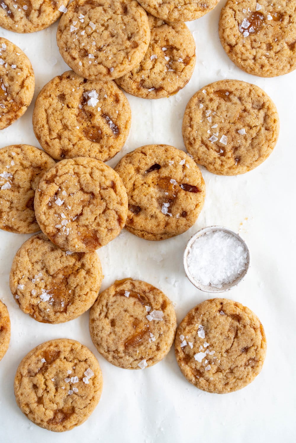 Salted caramel snickerdoodles - hard caramel is ground up and mixed into the cookie dough, then chunks of caramel are folded through to form chewy pockets once the cookie has baked. The perfect crowd pleasing christmas cookie.