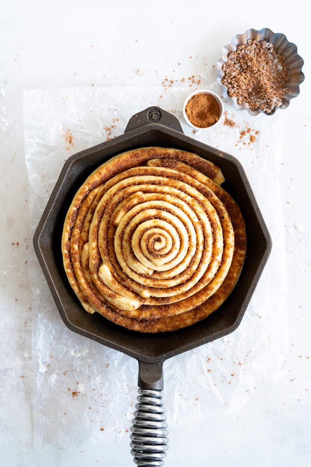 Giant Skillet Cinnamon Roll with Cream Cheese Icing - from Holiday and Celebration bread in five minutes a day. No knead brioche is covered in cinnamon sugar and rolled into a giant cinnamon roll - the most amazing twist on the traditional roll, and perfect for Christmas morning.