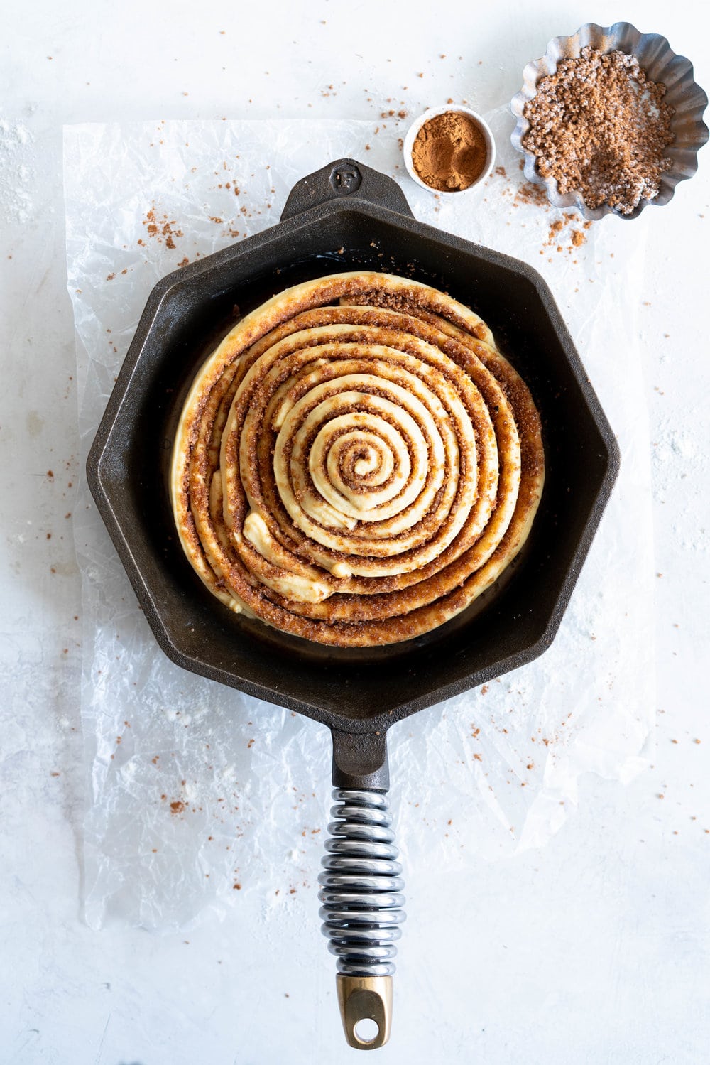 Giant Skillet Cinnamon Roll with Cream Cheese Icing - from Holiday and Celebration bread in five minutes a day. No knead brioche is covered in cinnamon sugar and rolled into a giant cinnamon roll - the most amazing twist on the traditional roll, and perfect for Christmas morning.