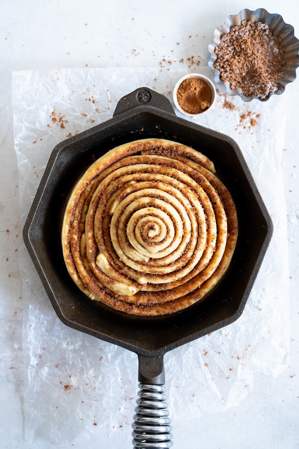 Giant Skillet Cinnamon Roll with Cream Cheese Icing - from Holiday and Celebration bread in five minutes a day. No knead brioche is covered in cinnamon sugar and rolled into a giant cinnamon roll - the most amazing twist on the traditional roll, and perfect for Christmas morning.