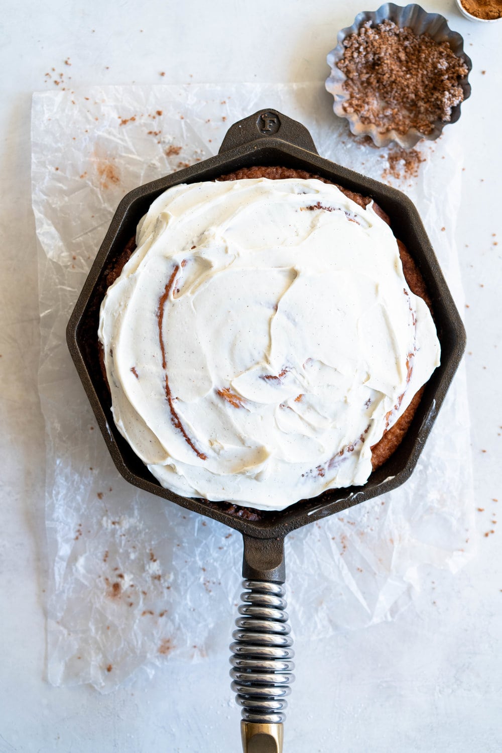 Giant Skillet Cinnamon Roll with Cream Cheese Icing - from Holiday and Celebration bread in five minutes a day. No knead brioche is covered in cinnamon sugar and rolled into a giant cinnamon roll - the most amazing twist on the traditional roll, and perfect for Christmas morning.