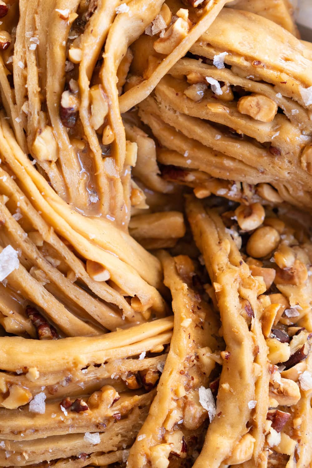 Brioche dough is spiked with vanilla bean and muscovado sugar, and spread with dulce de leche and sprinkled with mixed nuts. The finished knot is dusted with powdered sugar - the perfect christmas treat to feed a crowd.