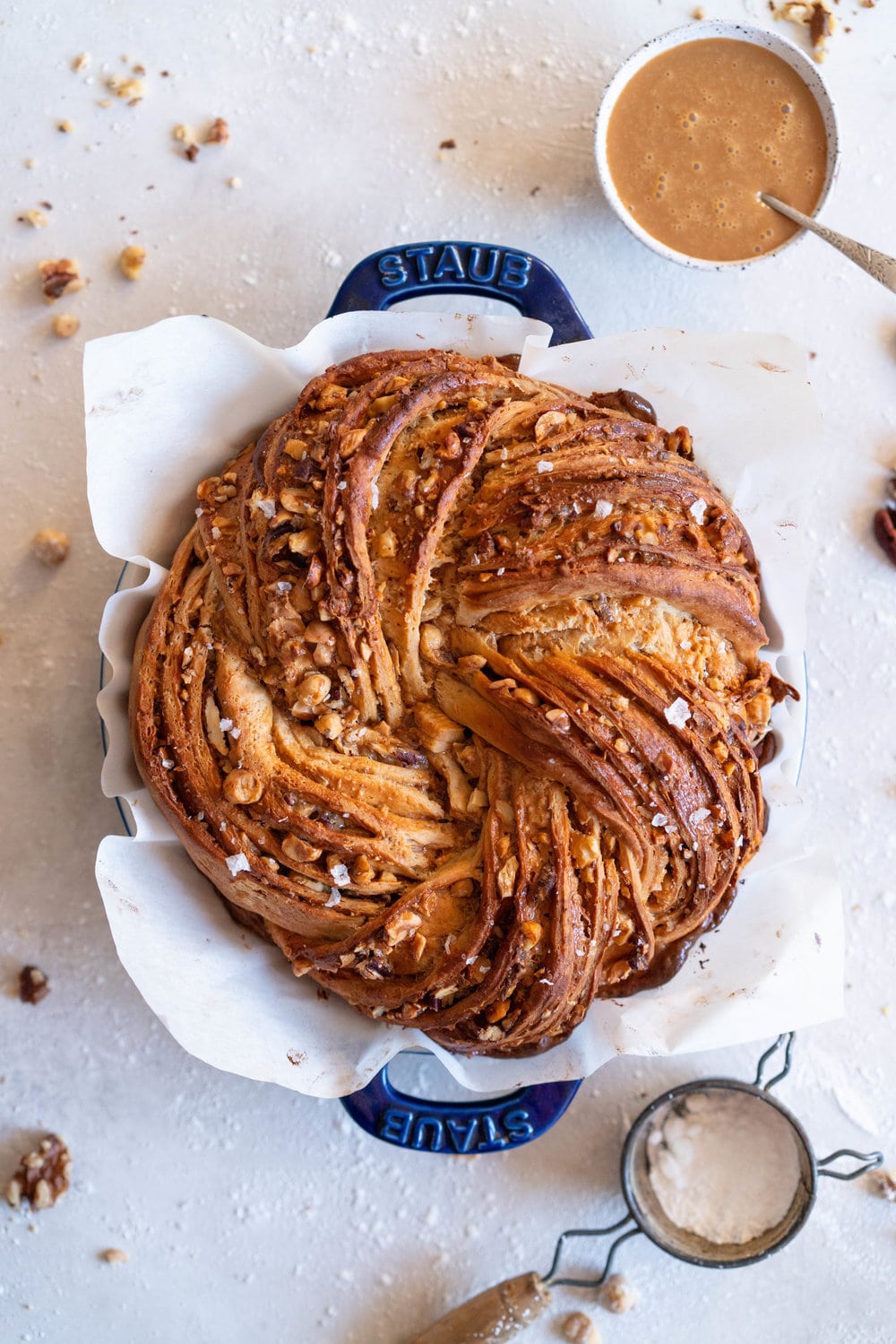 Brioche dough is spiked with vanilla bean and muscovado sugar, and spread with dulce de leche and sprinkled with mixed nuts. The finished knot is dusted with powdered sugar - the perfect christmas treat to feed a crowd.