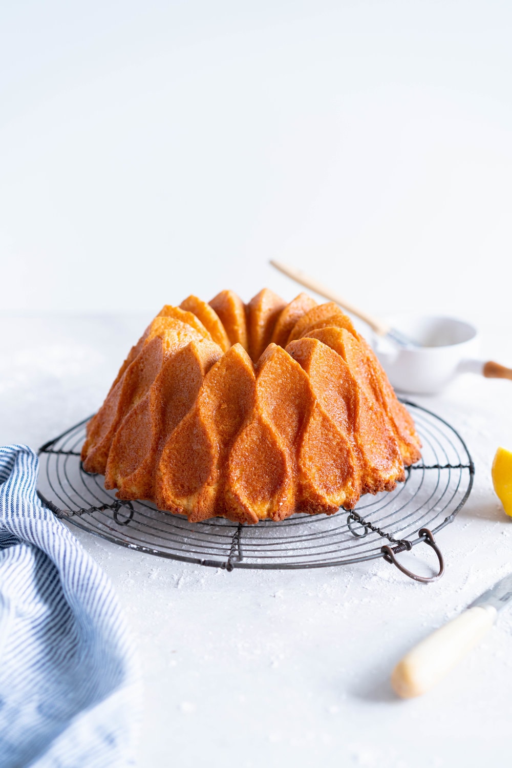 Olive Oil, Lemon, and Yoghurt Bundt Cake - a simple cake which comes together in two bowls, no fancy equipment required. Perfectly dense, flavoured with tangy greek yoghurt and floral, fruity olive oil. the perfect cake for any occasion. #bundtcake #lemonbundt