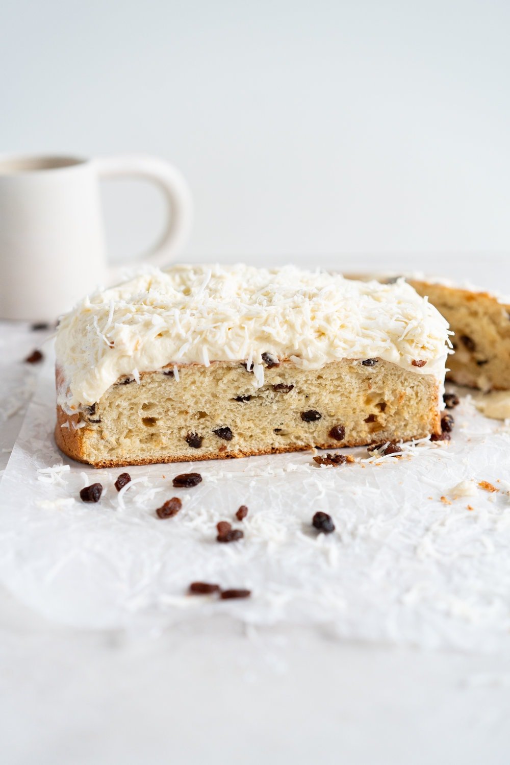 Boston Bun is a raisin brioche bun, covered with vanilla icing, and finished with shredded coconut. It is super easy to make, requires no fancy equipment or dough twisting, and makes the perfect treat with a cup of coffee or to entertain guests. #bostonbun #sallylunn #raisinbrioche