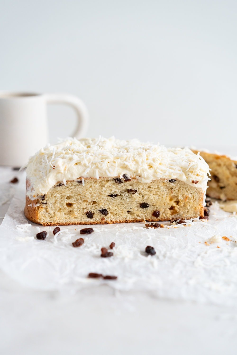 Boston Bun is a raisin brioche bun, covered with vanilla icing, and finished with shredded coconut. It is super easy to make, requires no fancy equipment or dough twisting, and makes the perfect treat with a cup of coffee or to entertain guests. #bostonbun #sallylunn #raisinbrioche