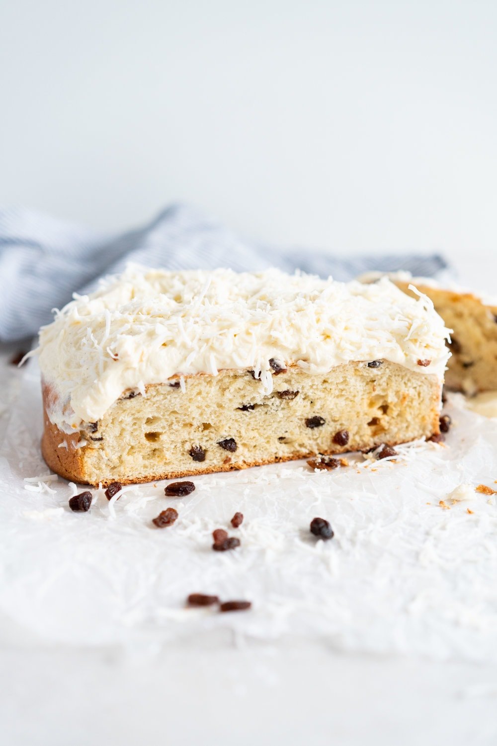Boston Bun is a raisin brioche bun, covered with vanilla icing, and finished with shredded coconut. It is super easy to make, requires no fancy equipment or dough twisting, and makes the perfect treat with a cup of coffee or to entertain guests. #bostonbun #sallylunn #raisinbrioche