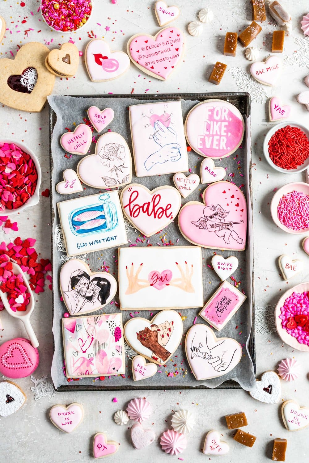 The Ultimate Valentine's Day treat box - a perfect mix of cookies and sweet treats to help celebrate valentine's day or the ones you love. This would make the most amazing gift - we included macarons, painted sugar cookies, linzer cookies, chocolate sandwich cookies, meringue kisses, soft earl grey caramels, and marshmallow hearts. #valentinesday #cookiebox