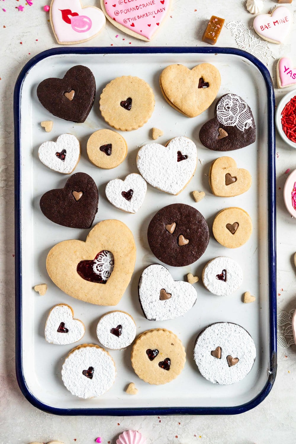 The Ultimate Valentine's Day treat box - a perfect mix of cookies and sweet treats to help celebrate valentine's day or the ones you love. This would make the most amazing gift - we included macarons, painted sugar cookies, linzer cookies, chocolate sandwich cookies, meringue kisses, soft earl grey caramels, and marshmallow hearts. #valentinesday #cookiebox