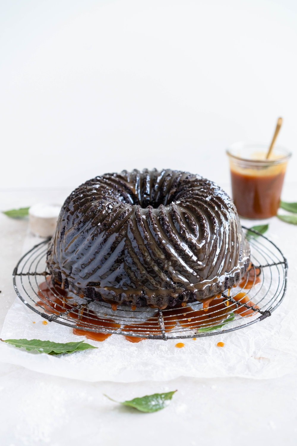 One Bowl Devil's food bundt cake with bay leaf caramel - a dense, moist chocolate bundt cake is loaded up with a lightly infused bay caramel. The cake is amazing alone, but with the caramel it is the perfect match. #devilsfoodcake #chocolatebundtcake #baycaramel