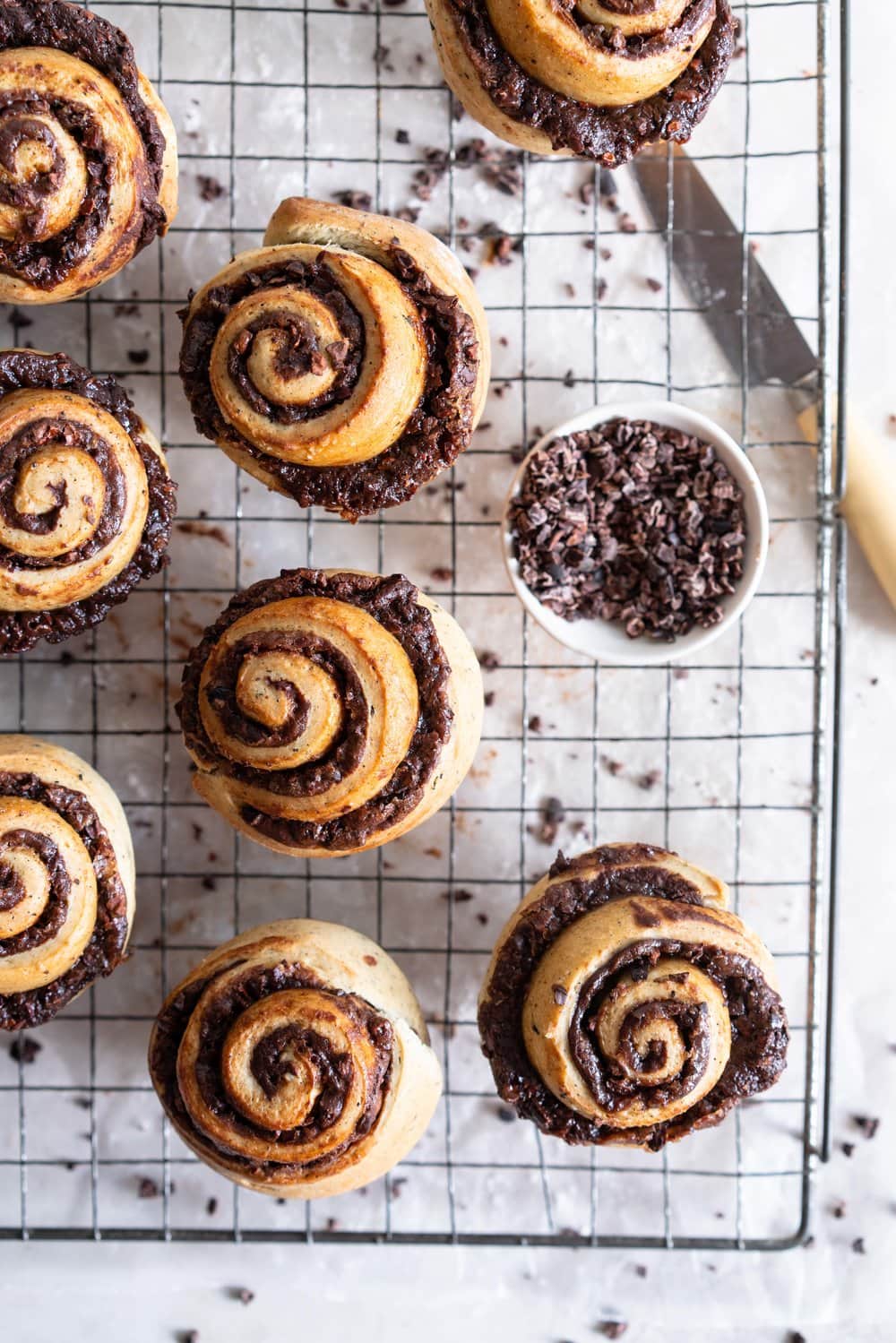 Earl Grey Buns with Dark Chocolate and Cocoa Nib Filling. Fluffy brioche dough is filled with an earl grey dark chocolate custard, and a crunchy cacao nib filling, then rolled up and sliced into buns. Once baked, the rolls are brushed with butter and rolled in a cocoa nib earl grey sugar. Rich and indulgent, and the most perfect treat. #earlgreybuns #chocolatebuns #earlgreycustard