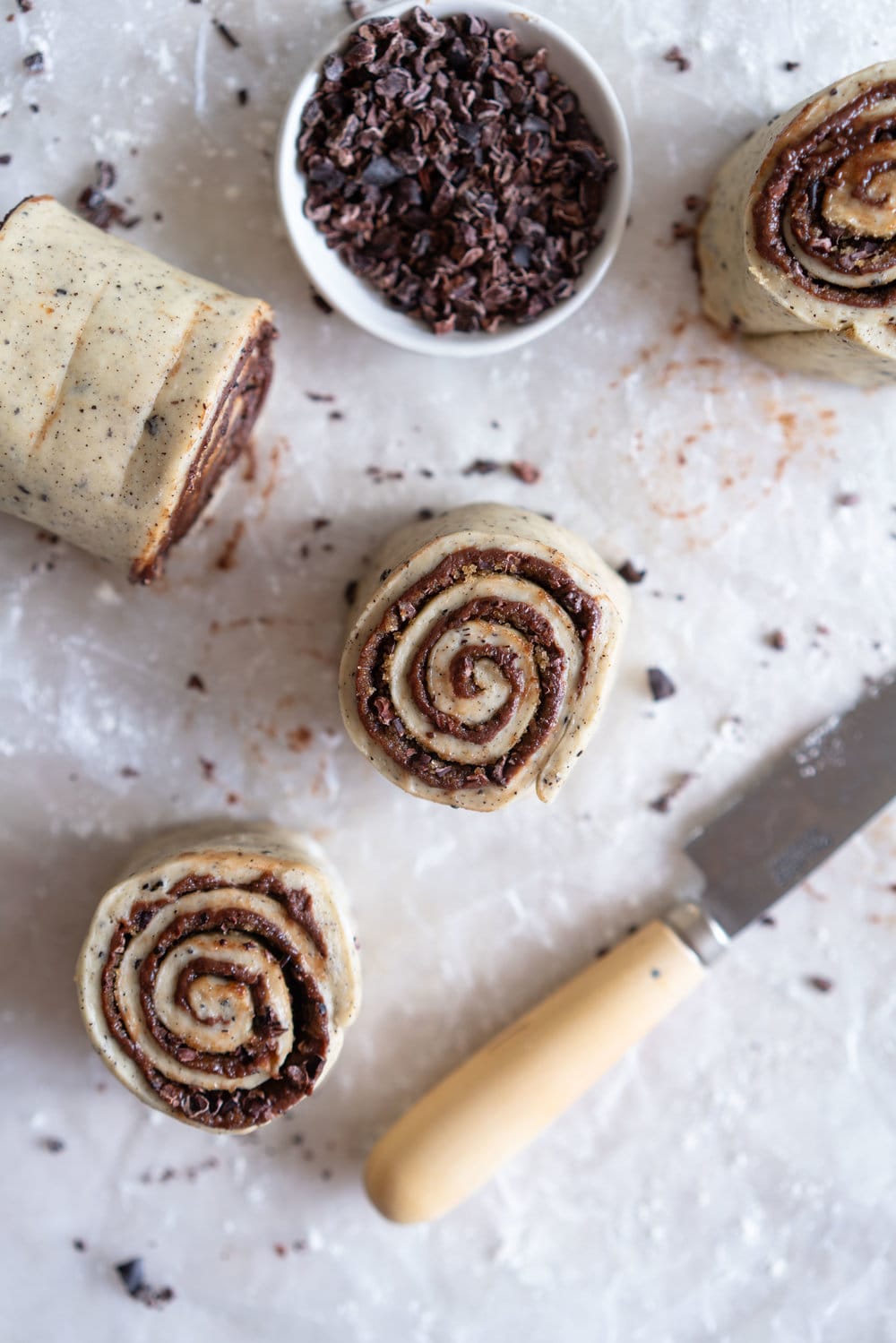 Earl Grey Buns with Dark Chocolate and Cocoa Nib Filling. Fluffy brioche dough is filled with an earl grey dark chocolate custard, and a crunchy cacao nib filling, then rolled up and sliced into buns. Once baked, the rolls are brushed with butter and rolled in a cocoa nib earl grey sugar. Rich and indulgent, and the most perfect treat. #earlgreybuns #chocolatebuns #earlgreycustard