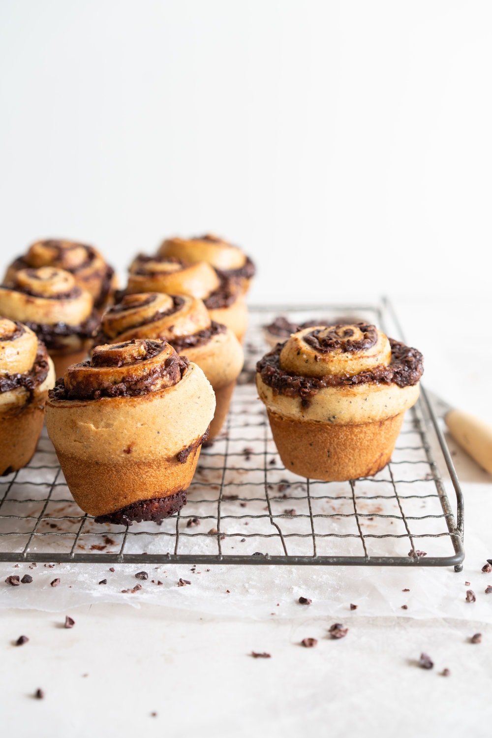 Earl Grey Buns with Dark Chocolate and Cocoa Nib Filling. Fluffy brioche dough is filled with an earl grey dark chocolate custard, and a crunchy cacao nib filling, then rolled up and sliced into buns. Once baked, the rolls are brushed with butter and rolled in a cocoa nib earl grey sugar. Rich and indulgent, and the most perfect treat. #earlgreybuns #chocolatebuns #earlgreycustard