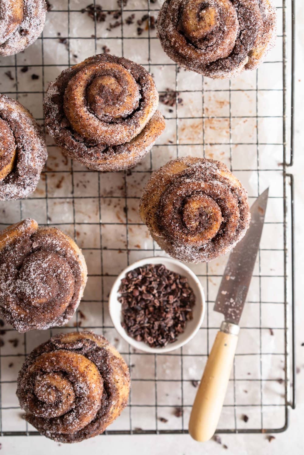 Earl Grey Buns with Dark Chocolate and Cocoa Nib Filling. Fluffy brioche dough is filled with an earl grey dark chocolate custard, and a crunchy cacao nib filling, then rolled up and sliced into buns. Once baked, the rolls are brushed with butter and rolled in a cocoa nib earl grey sugar. Rich and indulgent, and the most perfect treat. #earlgreybuns #chocolatebuns #earlgreycustard