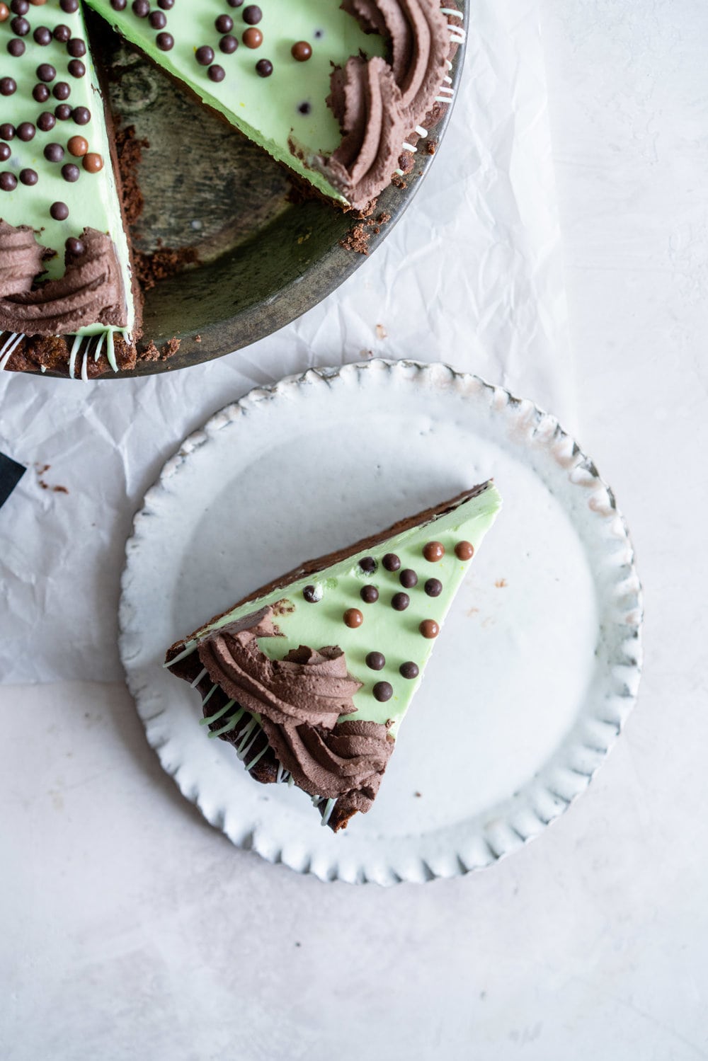 Double Chocolate Mint Chip Pie from 'The New Pie'. Chocolate pastry is drizzled with white and green chocolate, filled with a dark chocolate ganache, topped with chopped mints, then topped with a mint chocolate chip cream filling loaded up with crispy pearls. The whole thing is then finished with a cocoa whipped cream. If there was a pie version of the perfect scoop of mint chocolate chip ice cream, this pie would be it. #mintchip #doublechocolate #creampie
