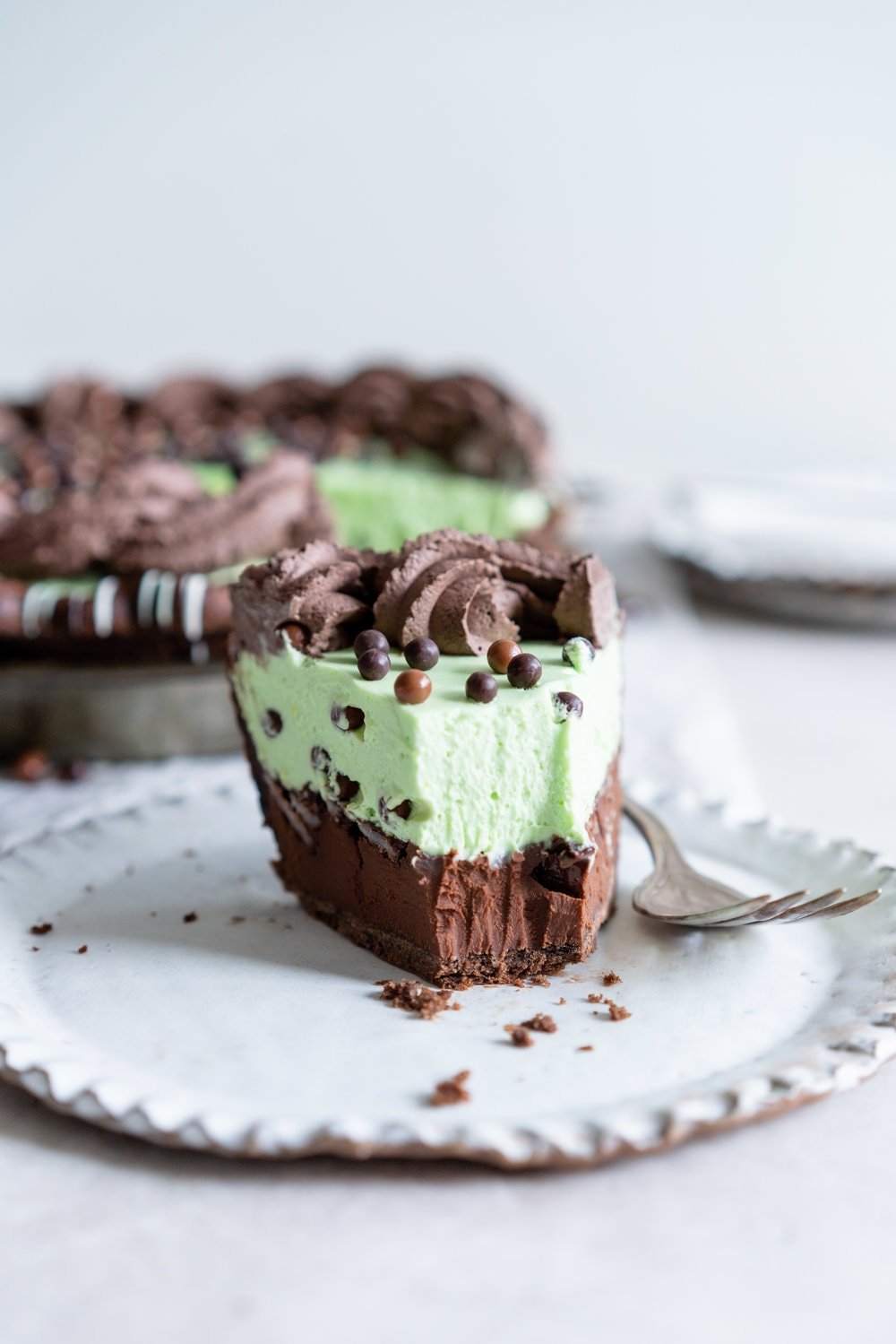 Double Chocolate Mint Chip Pie from 'The New Pie'. Chocolate pastry is drizzled with white and green chocolate, filled with a dark chocolate ganache, topped with chopped mints, then topped with a mint chocolate chip cream filling loaded up with crispy pearls. The whole thing is then finished with a cocoa whipped cream. If there was a pie version of the perfect scoop of mint chocolate chip ice cream, this pie would be it. #mintchip #doublechocolate #creampie