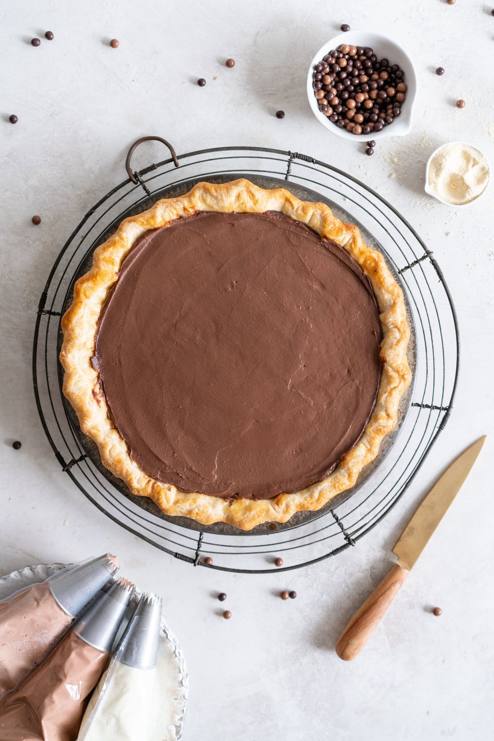 Malted Dark Chocolate Cream Pie with Cream Cheese Whip. A flaky pie crust is topped with a silky malted dark chocolate pudding, and topped with a chocolate and vanilla bean piped cream cheese whipped cream. #creamcheese #chocolatepie #maltedmilk