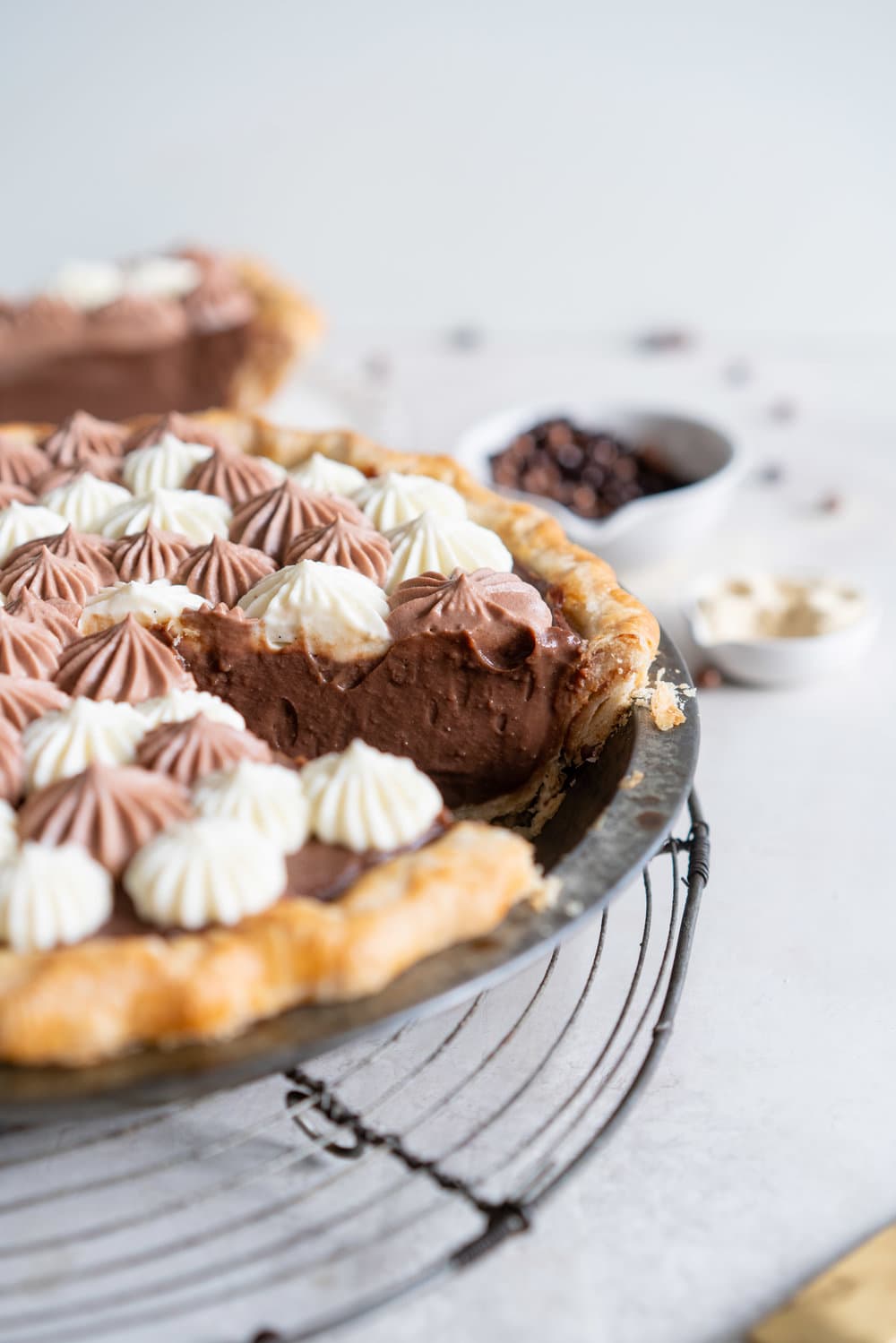 Malted Dark Chocolate Cream Pie with Cream Cheese Whip. A flaky pie crust is topped with a silky malted dark chocolate pudding, and topped with a chocolate and vanilla bean piped cream cheese whipped cream. #creamcheese #chocolatepie #maltedmilk
