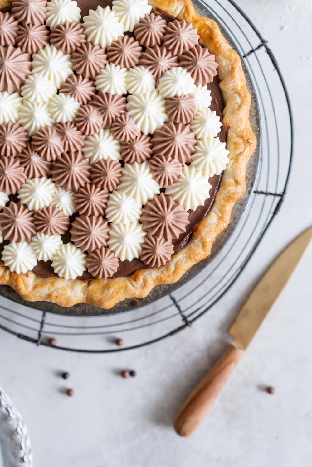 Malted Dark Chocolate Cream Pie with Cream Cheese Whip. A flaky pie crust is topped with a silky malted dark chocolate pudding, and topped with a chocolate and vanilla bean piped cream cheese whipped cream. #creamcheese #chocolatepie #maltedmilk