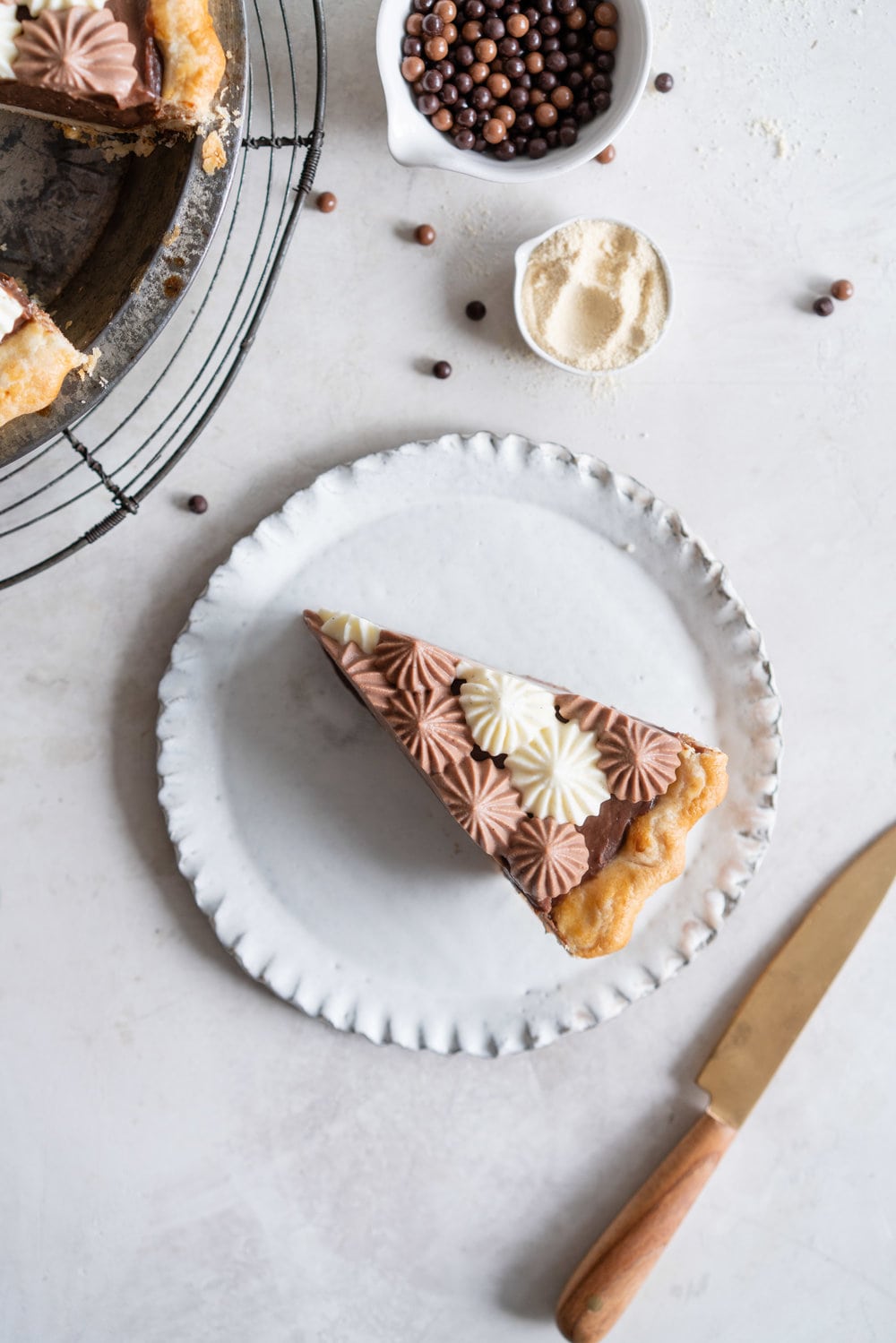 Malted Dark Chocolate Cream Pie with Cream Cheese Whip. A flaky pie crust is topped with a silky malted dark chocolate pudding, and topped with a chocolate and vanilla bean piped cream cheese whipped cream. #creamcheese #chocolatepie #maltedmilk