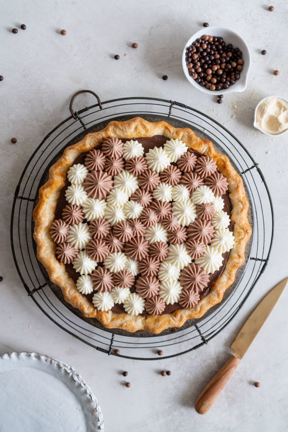 Malted Dark Chocolate Cream Pie with Cream Cheese Whip. A flaky pie crust is topped with a silky malted dark chocolate pudding, and topped with a chocolate and vanilla bean piped cream cheese whipped cream. #creamcheese #chocolatepie #maltedmilk