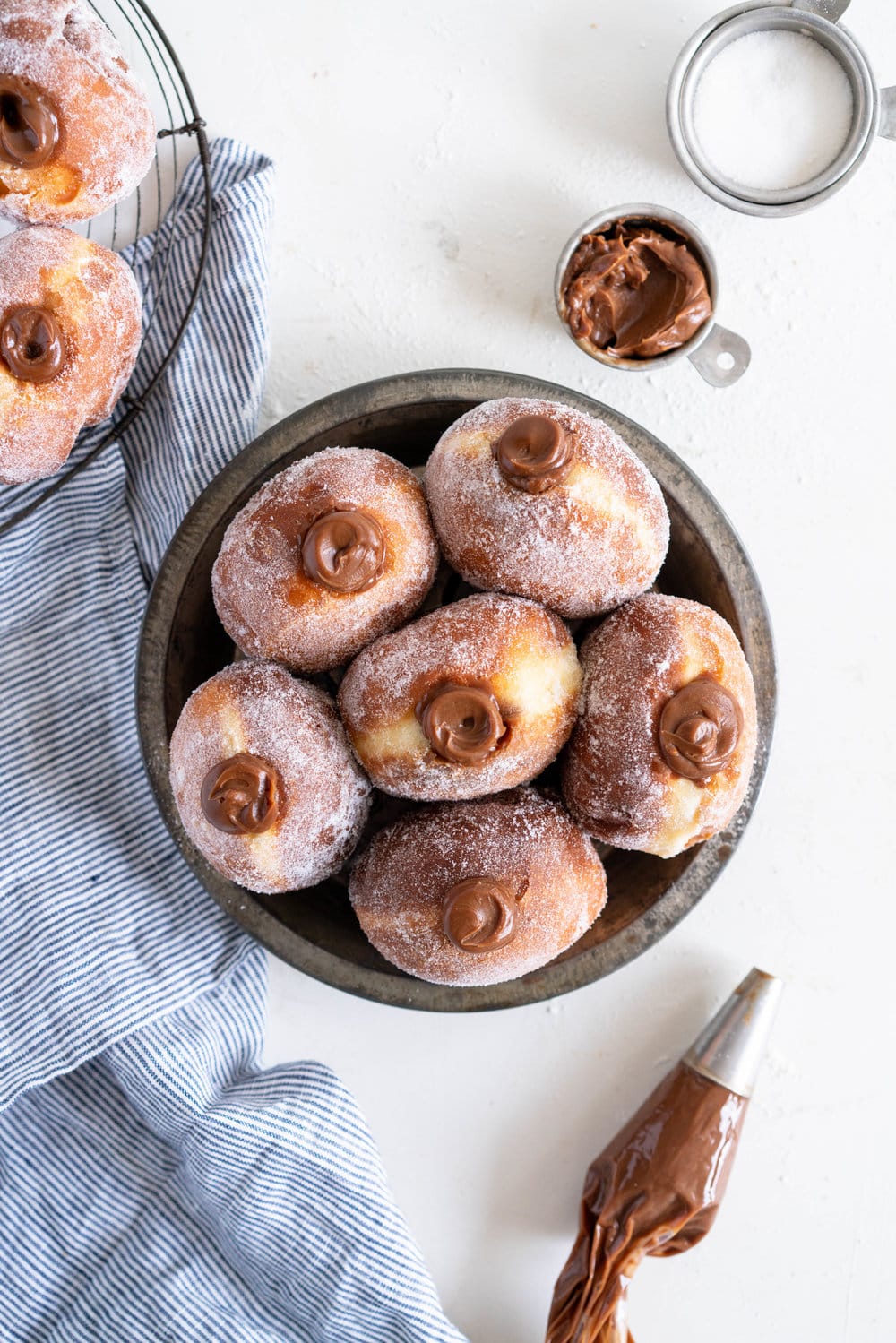 Salted Caramel and Milk Chocolate Ganache filled Brioche Doughnuts - Fluffy brioche doughnuts are rolled in sugar, then filled with a silky salted caramel and milk chocolate ganache. These are the ultimate treat - the rich chocolate ganache is a total game changer. #doughnuts #briochedoughnuts