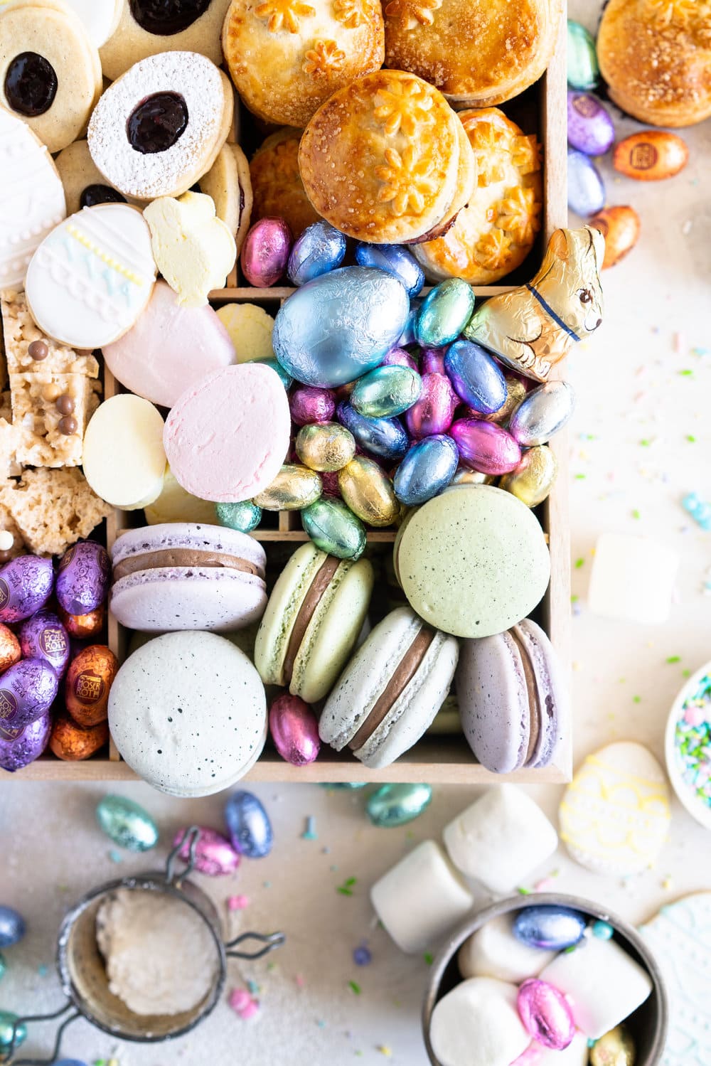 The Ultimate Easter treat box - iced cookies, cardamom linzers, hand pies, macarons, crispy rice treats and Easter mallows make the most amazing treat box, and are complimented perfectly by super cute foil wrapped chocolate eggs. This box would make the most perfect Easter gift, or the components are perfect alone for Easter treats. #easterbox #cookiebox #easterbaking