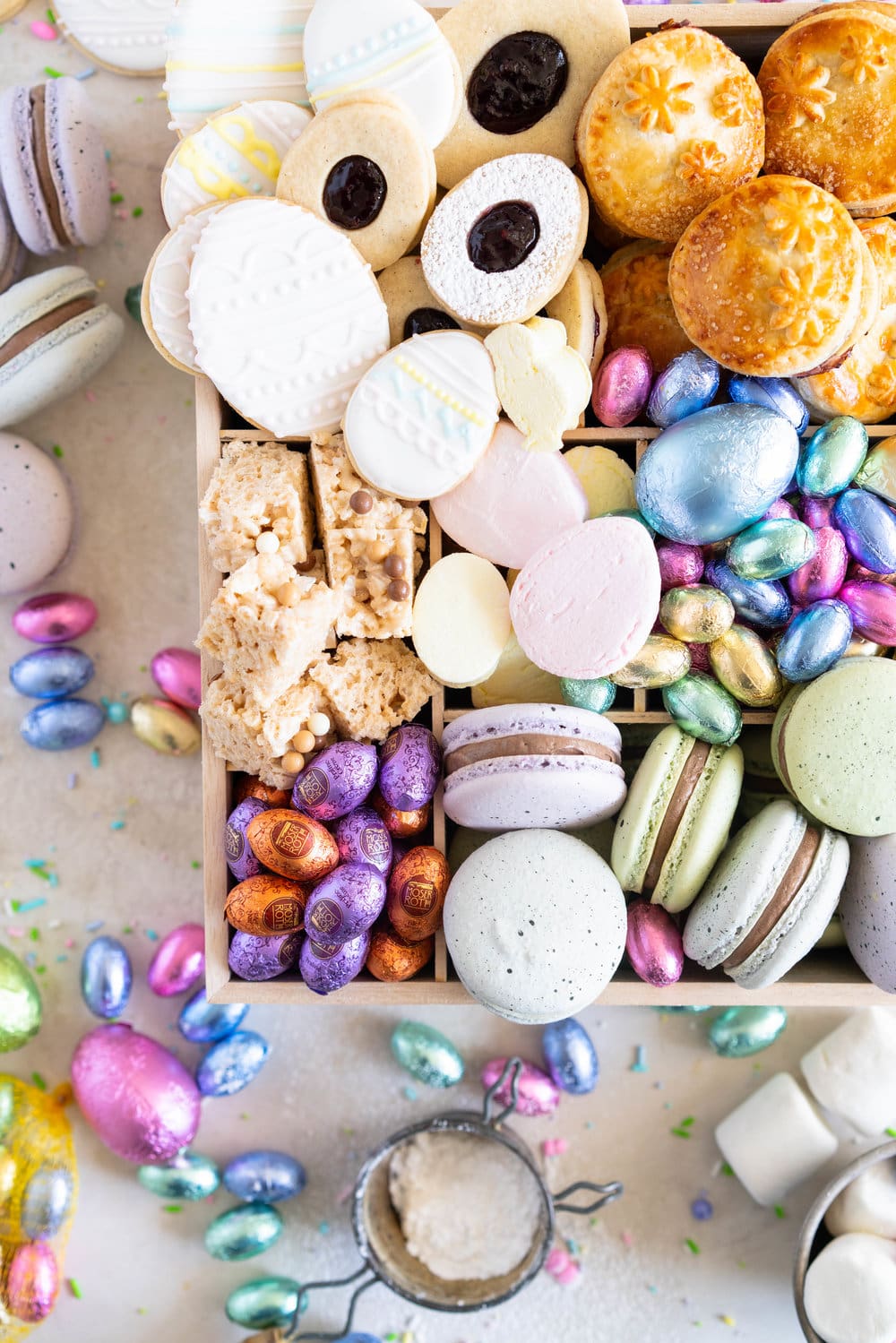The Ultimate Easter treat box - iced cookies, cardamom linzers, hand pies, macarons, crispy rice treats and Easter mallows make the most amazing treat box, and are complimented perfectly by super cute foil wrapped chocolate eggs. This box would make the most perfect Easter gift, or the components are perfect alone for Easter treats. #easterbox #cookiebox #easterbaking