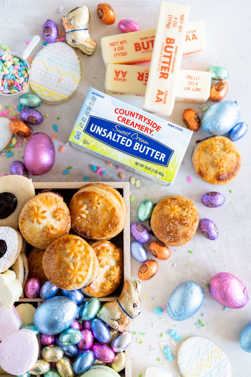 The Ultimate Easter treat box - iced cookies, cardamom linzers, hand pies, macarons, crispy rice treats and Easter mallows make the most amazing treat box, and are complimented perfectly by super cute foil wrapped chocolate eggs. This box would make the most perfect Easter gift, or the components are perfect alone for Easter treats. #easterbox #cookiebox #easterbaking