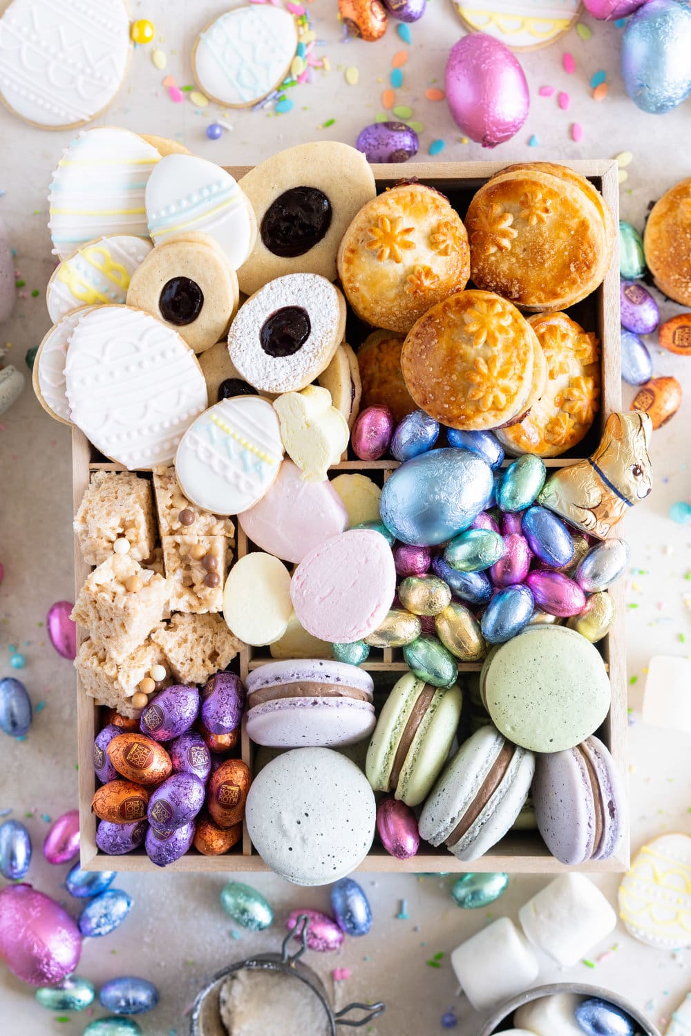 The Ultimate Easter treat box - iced cookies, cardamom linzers, hand pies, macarons, crispy rice treats and Easter mallows make the most amazing treat box, and are complimented perfectly by super cute foil wrapped chocolate eggs. This box would make the most perfect Easter gift, or the components are perfect alone for Easter treats. #easterbox #cookiebox #easterbaking