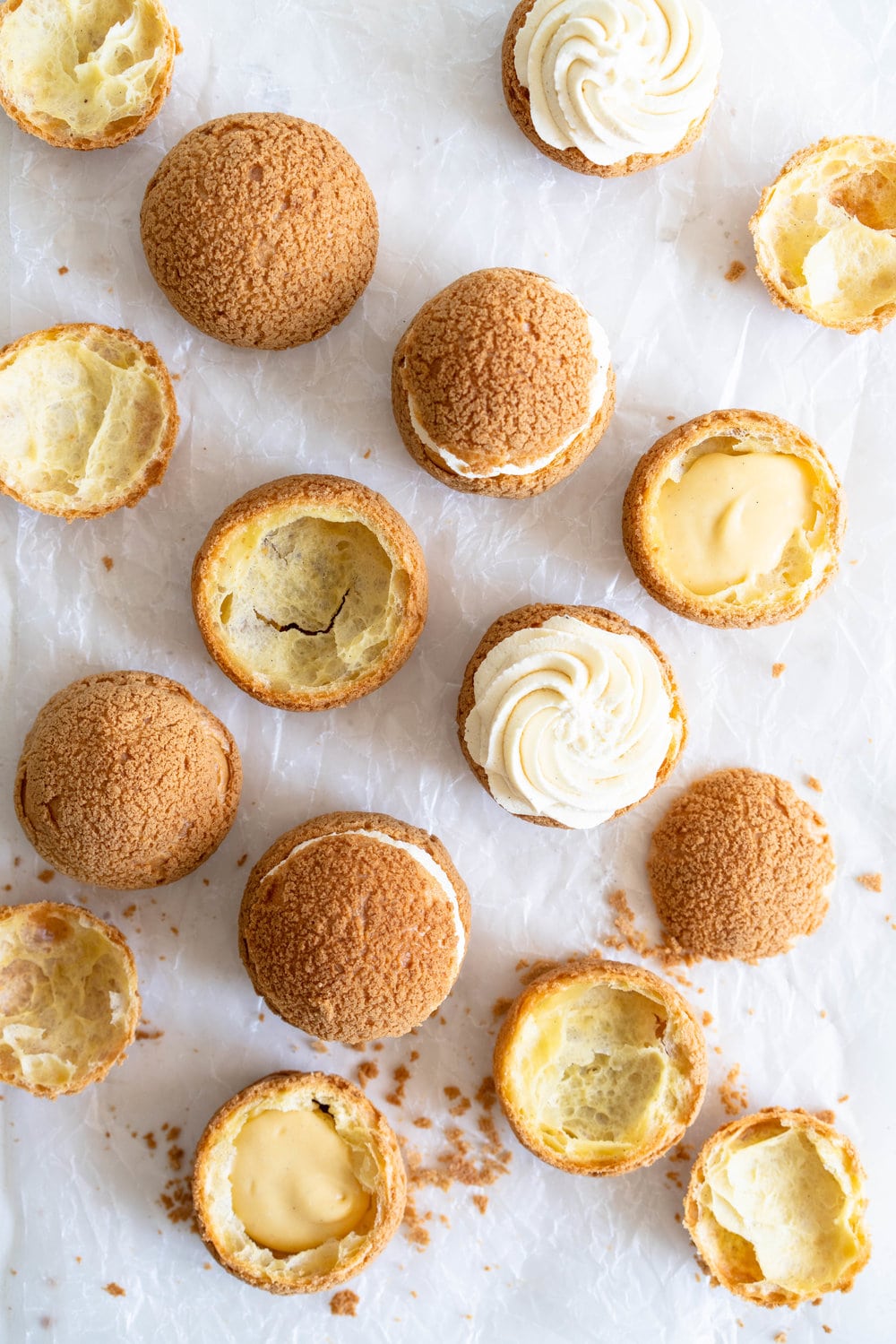 Choux au Craquelin - Cream Puffs with Passionfruit Cream and Passionfruit Whipped Cream. Crispy, light cream puffs, topped with crunchy craquelin, are filled with a tart passionfruit cream, then topped with a smooth passionfruit whipped cream. The perfect dessert for if you are feeling a little fancy! #creampuffs #passionfruit