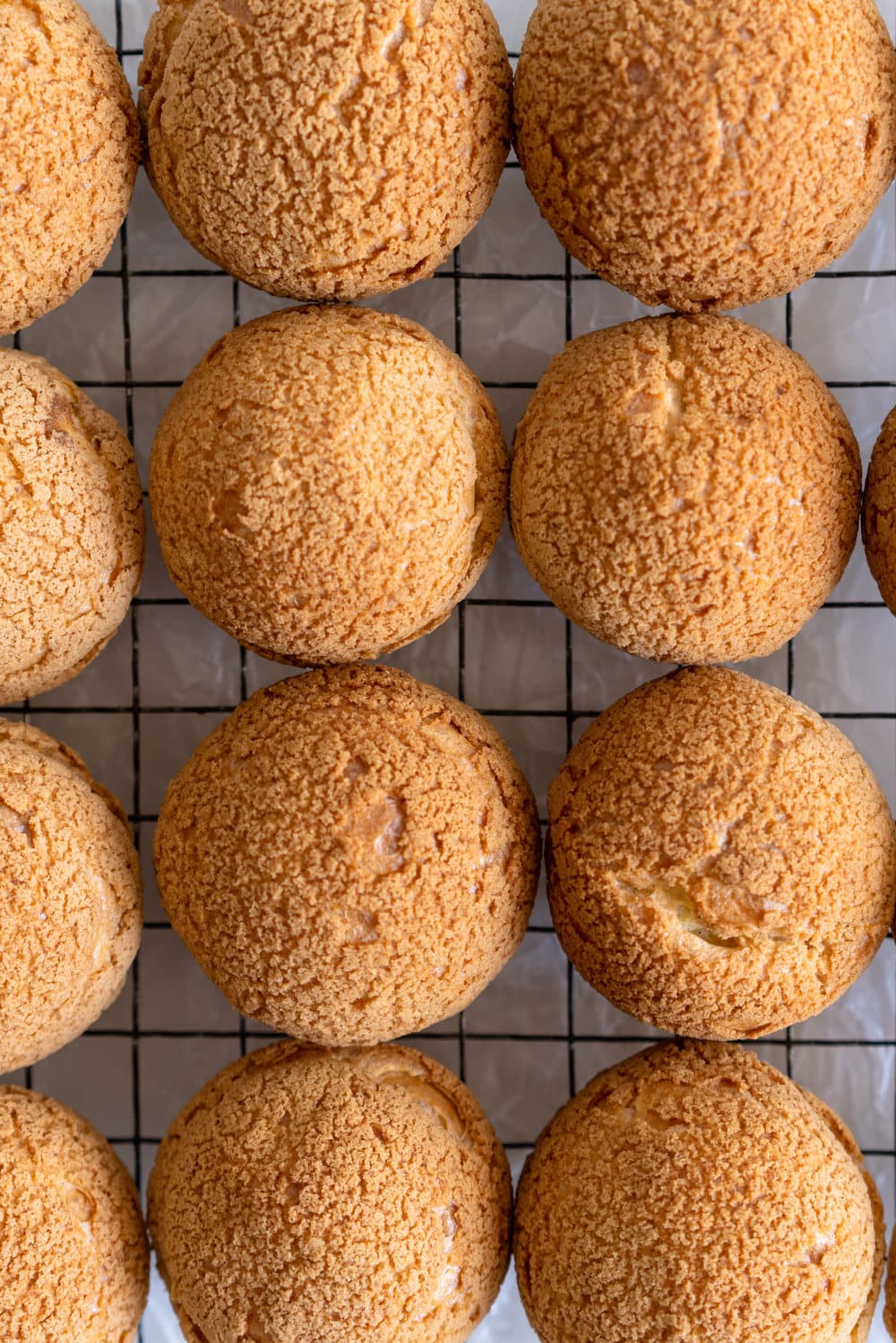 Choux au Craquelin - Cream Puffs with Passionfruit Cream and Passionfruit Whipped Cream. Crispy, light cream puffs, topped with crunchy craquelin, are filled with a tart passionfruit cream, then topped with a smooth passionfruit whipped cream. The perfect dessert for if you are feeling a little fancy! #creampuffs #passionfruit