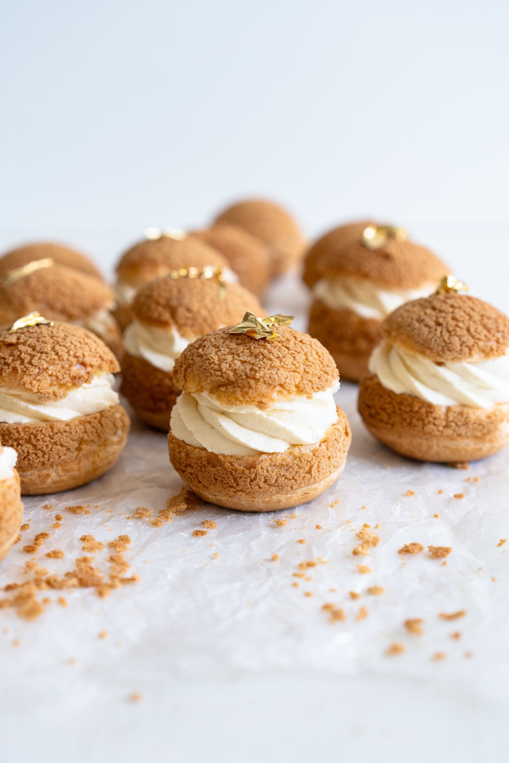 Choux au Craquelin - Cream Puffs with Passionfruit Cream and Passionfruit Whipped Cream. Crispy, light cream puffs, topped with crunchy craquelin, are filled with a tart passionfruit cream, then topped with a smooth passionfruit whipped cream. The perfect dessert for if you are feeling a little fancy! #creampuffs #passionfruit