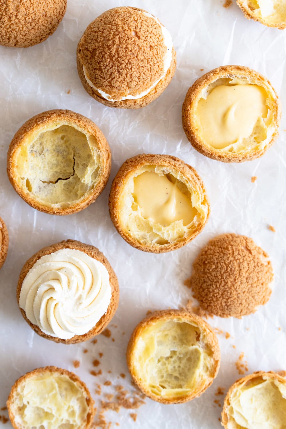 Choux au Craquelin - Cream Puffs with Passionfruit Cream and Passionfruit Whipped Cream. Crispy, light cream puffs, topped with crunchy craquelin, are filled with a tart passionfruit cream, then topped with a smooth passionfruit whipped cream. The perfect dessert for if you are feeling a little fancy! #creampuffs #passionfruit