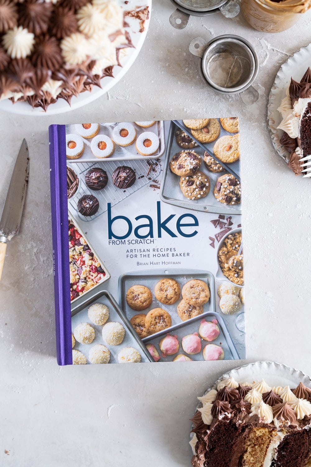 Chocolate and Peanut Butter Layer Cake with Chocolate and Peanut Butter Buttercream - this party cake is from the latest book from Bake from Scratch Magazine. Soft chocolate and peanut butter cake layers are sandwiched with chocolate and peanut butter buttercream, then finished off with playful blobs of the buttercream to create the perfect chocolate ombre cake. This cake is easy to make and is great to serve a crowd - you can't go wrong with peanut butter and chocolate! #chocolatecake #peanutbuttercake #chocolatebuttercream #peanutbutterbuttercream