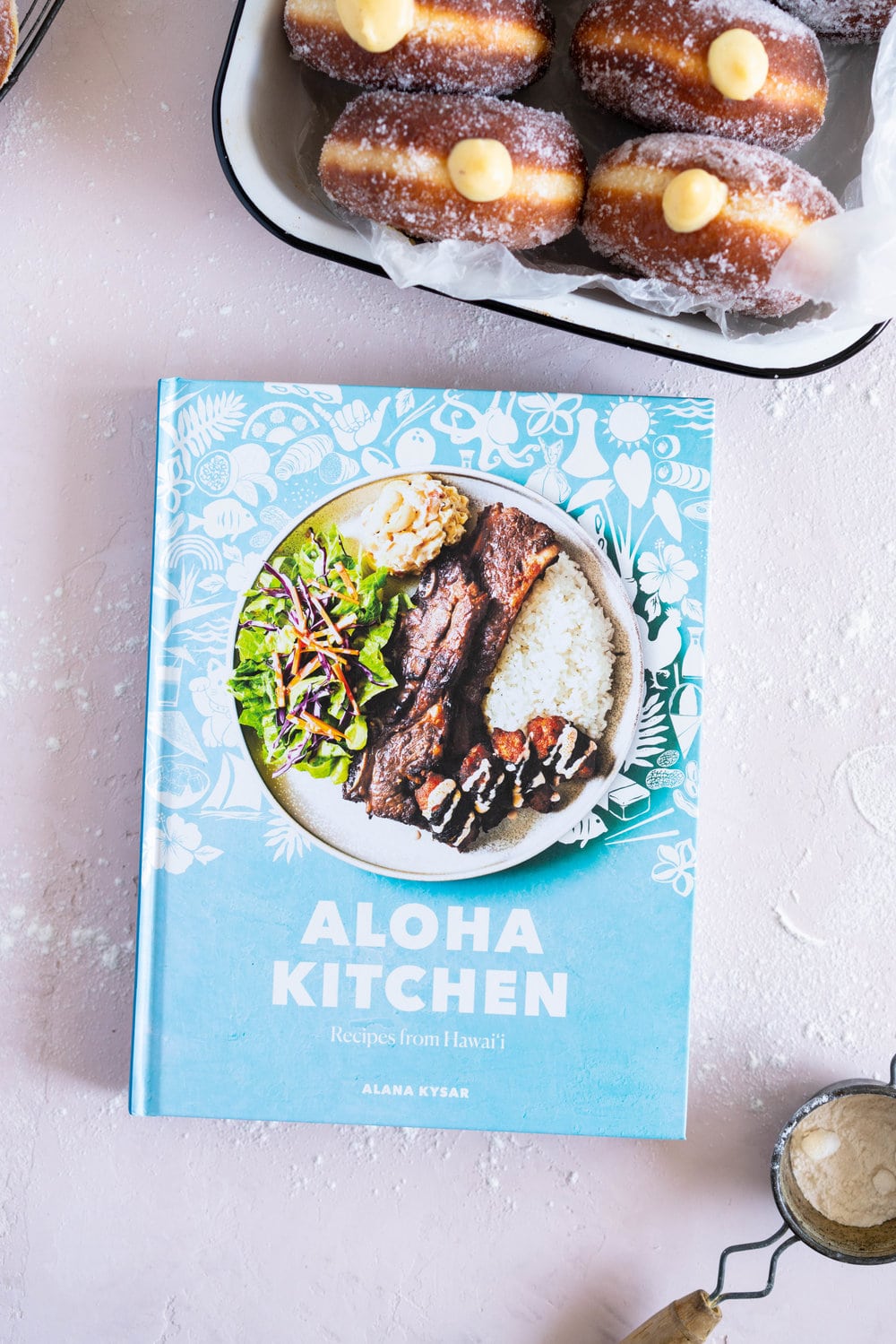 Malasadas with Liliko'i (Passionfruit) Pastry Cream Filling from Alana Kysar's new book, Aloha Kitchen. Malasadas are Portuguese style doughnuts, which are soft and fluffy. They are fried off, then rolled in sugar, then filled with a silky liliko'i pastry cream. These are the perfect indulgent treat, and are super easy to make. #malasadas #doughnuts #lilikoi #passionfruit