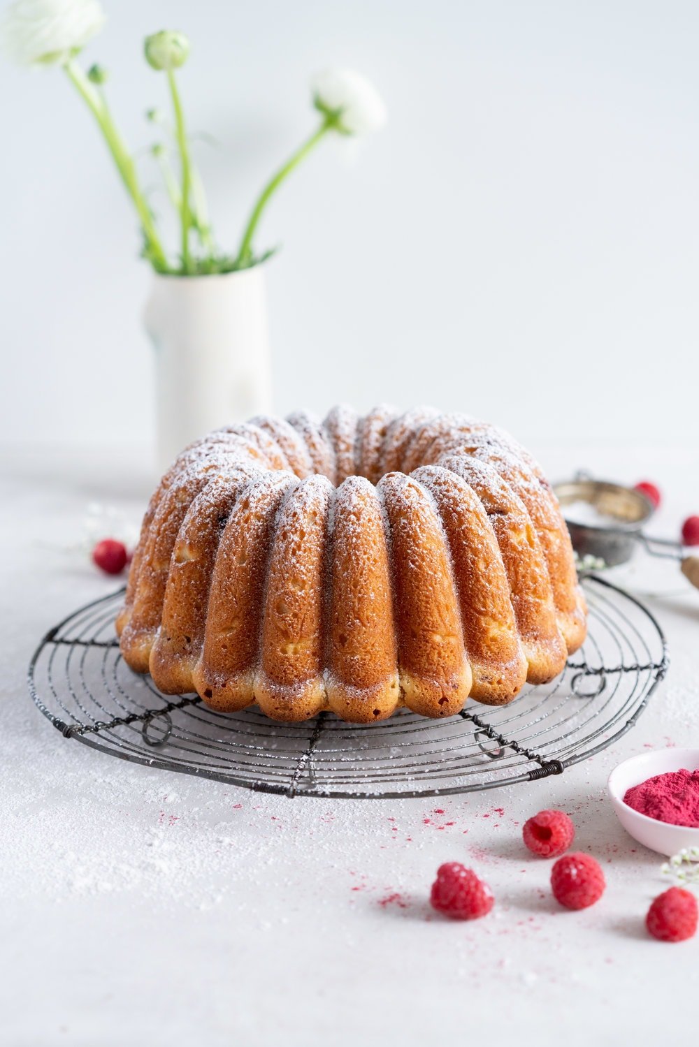 Raspberry Ricotta bundt cake - a tender vanilla bean bundt cake is accented with tart raspberries. This easy, stir together cake is the perfect texture, is simple to put together, and is perfect for feeding a crowd. #bundtcake #ricottacake #raspberrybundt