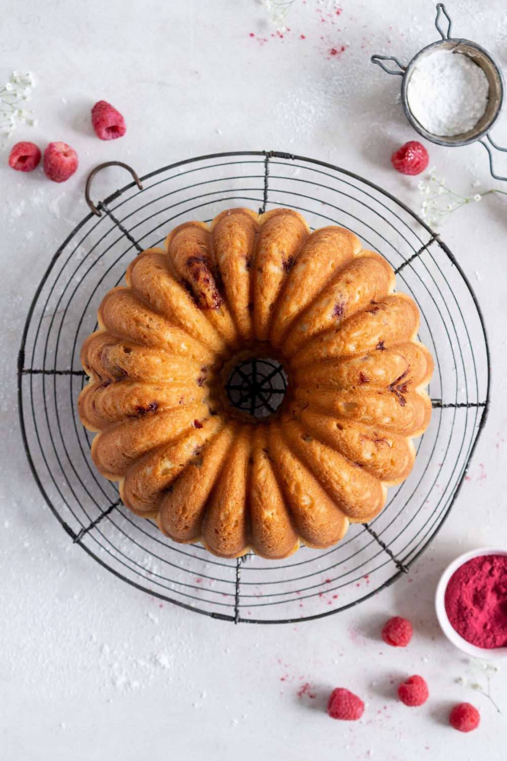 Raspberry Ricotta bundt cake - a tender vanilla bean bundt cake is accented with tart raspberries. This easy, stir together cake is the perfect texture, is simple to put together, and is perfect for feeding a crowd. #bundtcake #ricottacake #raspberrybundt