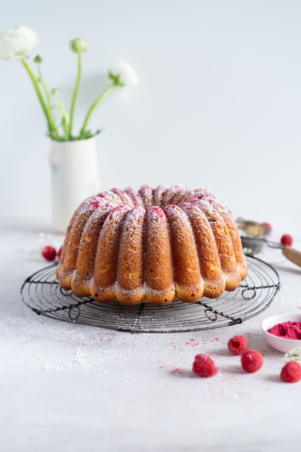 Raspberry Ricotta bundt cake - a tender vanilla bean bundt cake is accented with tart raspberries. This easy, stir together cake is the perfect texture, is simple to put together, and is perfect for feeding a crowd. #bundtcake #ricottacake #raspberrybundt
