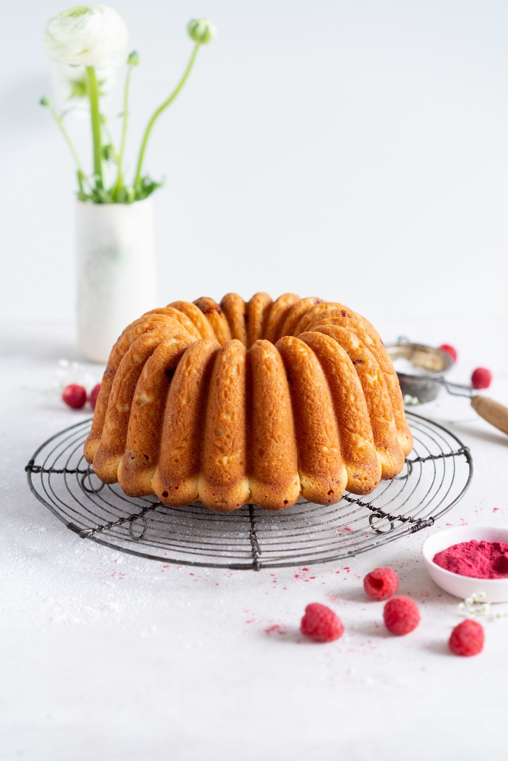 Raspberry Ricotta bundt cake - a tender vanilla bean bundt cake is accented with tart raspberries. This easy, stir together cake is the perfect texture, is simple to put together, and is perfect for feeding a crowd. #bundtcake #ricottacake #raspberrybundt