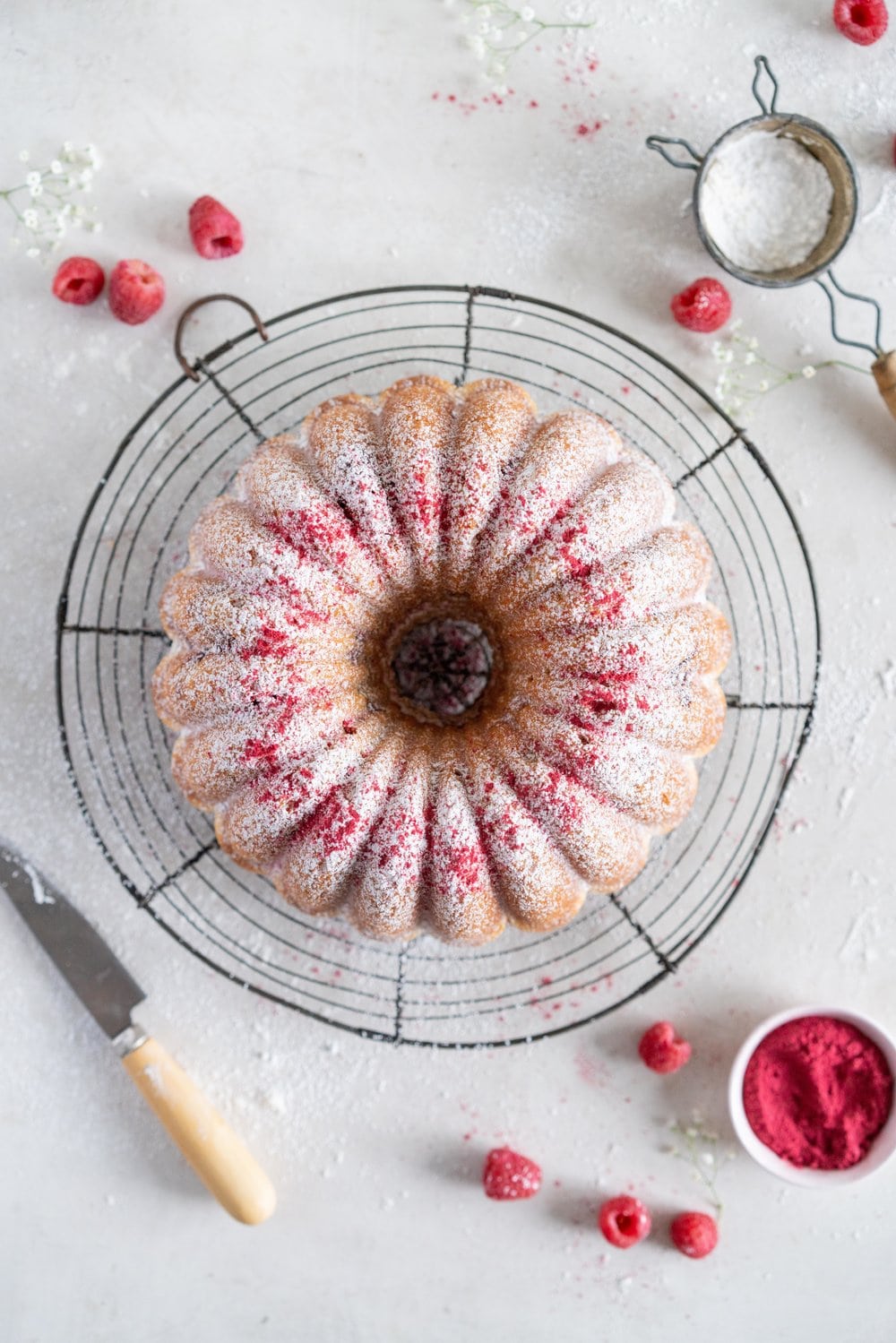 Raspberry Ricotta bundt cake - a tender vanilla bean bundt cake is accented with tart raspberries. This easy, stir together cake is the perfect texture, is simple to put together, and is perfect for feeding a crowd. #bundtcake #ricottacake #raspberrybundt