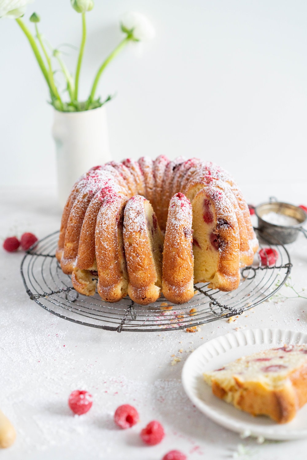 Raspberry Ricotta bundt cake - a tender vanilla bean bundt cake is accented with tart raspberries. This easy, stir together cake is the perfect texture, is simple to put together, and is perfect for feeding a crowd. #bundtcake #ricottacake #raspberrybundt