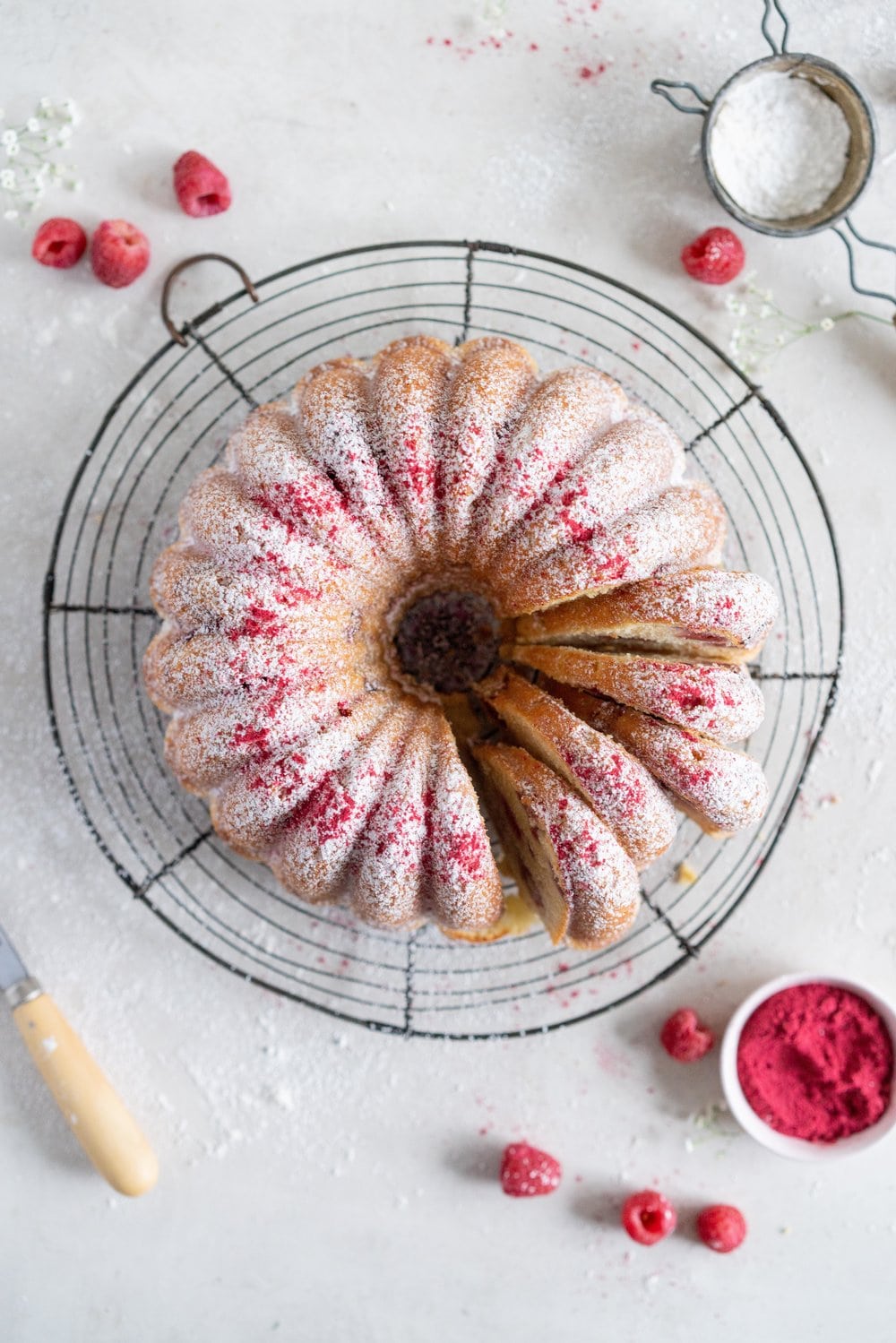Raspberry Ricotta bundt cake - a tender vanilla bean bundt cake is accented with tart raspberries. This easy, stir together cake is the perfect texture, is simple to put together, and is perfect for feeding a crowd. #bundtcake #ricottacake #raspberrybundt