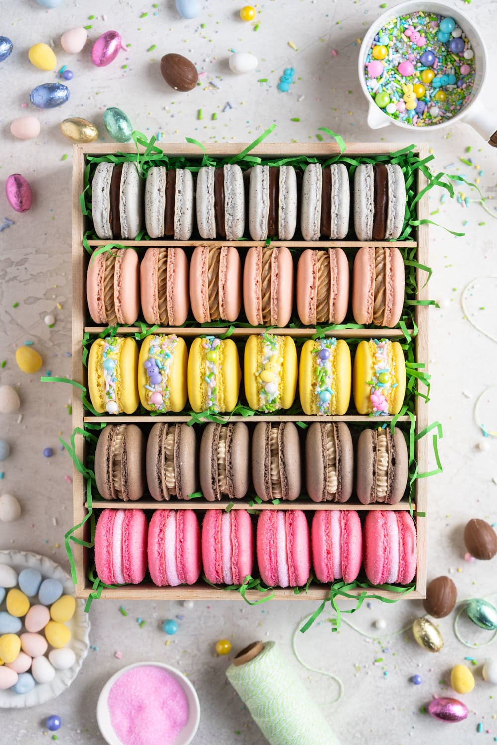 The ultimate Easter Macaron Box - creme egg macarons, hot cross bun macarons, coconut macarons, chocolate peanut butter macarons and peeps marshmallow macarons make up the most amazing Easter inspired box. This would make an incredible easter gift, and can be customised however you like!