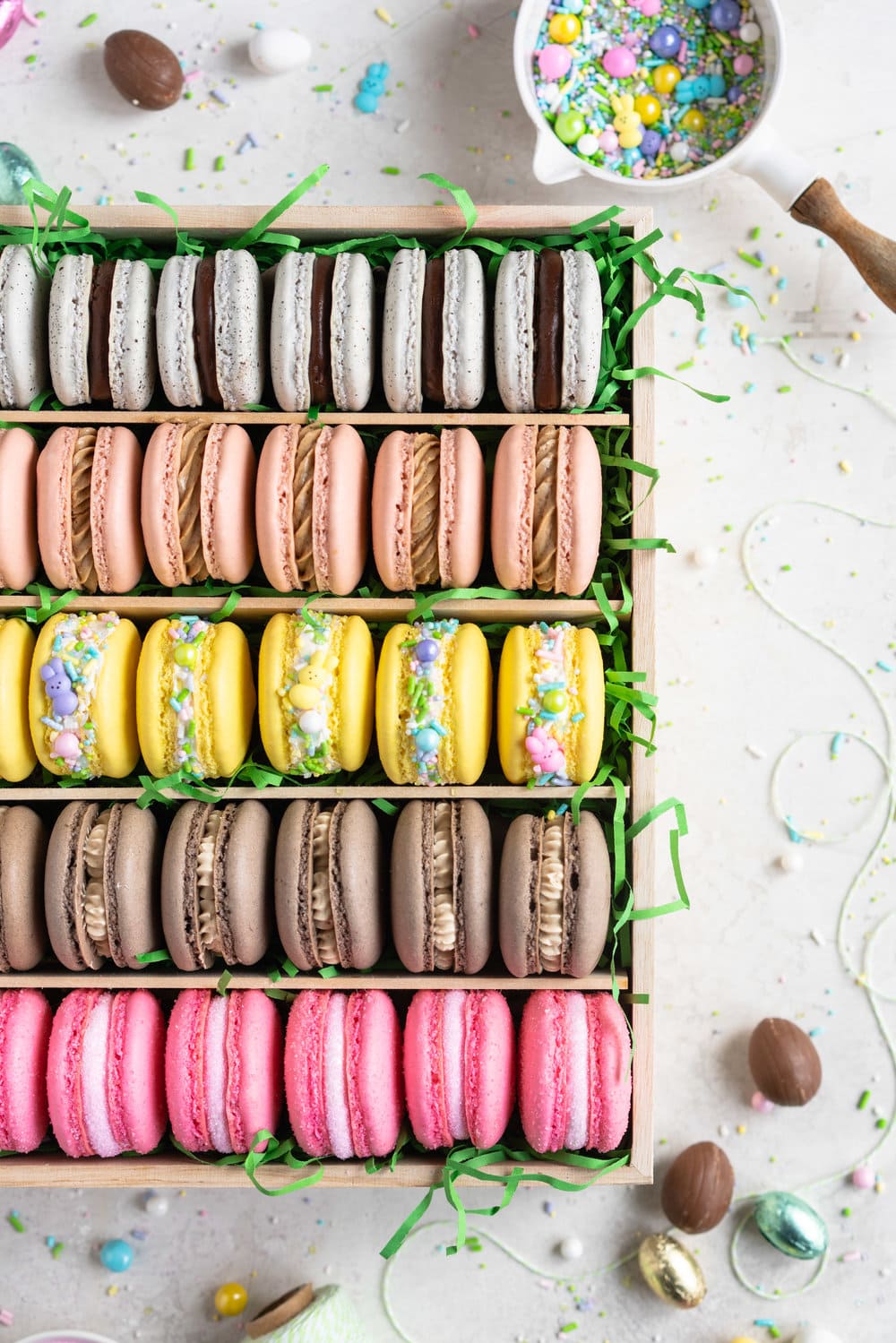 The ultimate Easter Macaron Box - creme egg macarons, hot cross bun macarons, coconut macarons, chocolate peanut butter macarons and peeps marshmallow macarons make up the most amazing Easter inspired box. This would make an incredible easter gift, and can be customised however you like!