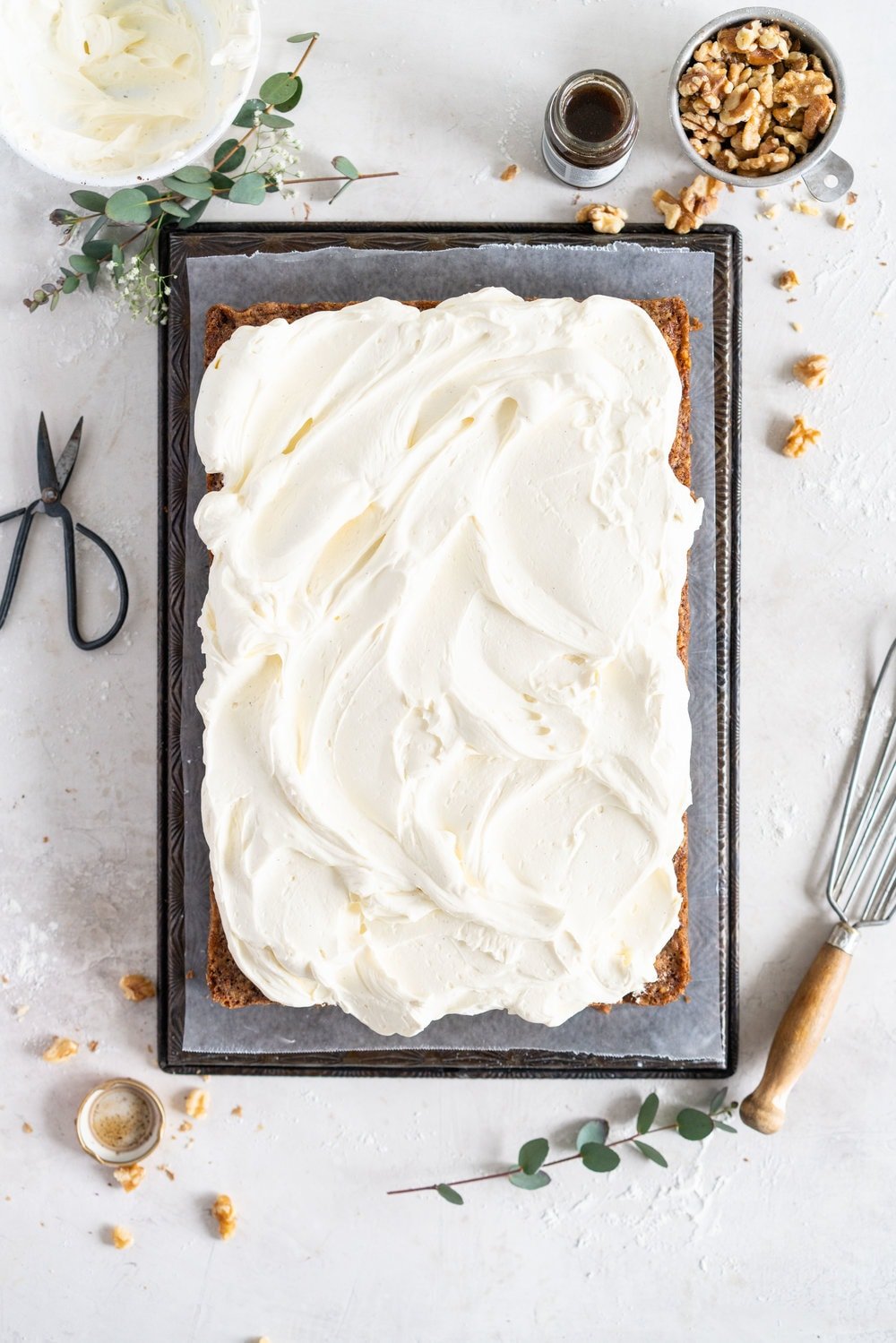 Brown Butter Carrot Sheet Cake is taken to the next level with a fluffy, whipped vanilla bean cream cheese german buttercream. This cake comes together super easily but is super delicious, and would make the perfect easter dessert. #brownbutter #carrotcake #sheetcake #germanbuttercream